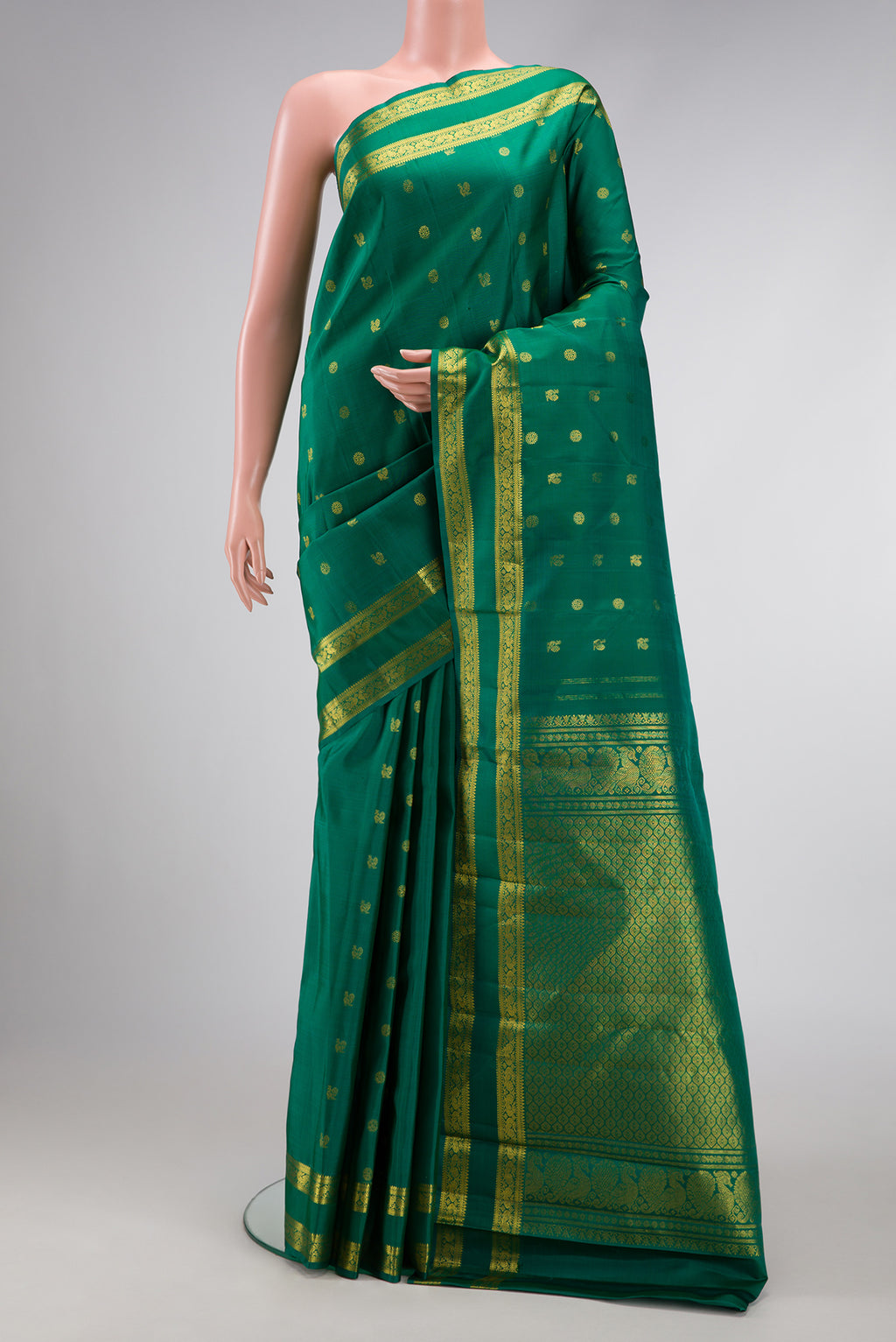 Green Dual Tone Kanjivaram Silk Saree with Zari Butta on the body and Zari Border.  displayed on a mannequin