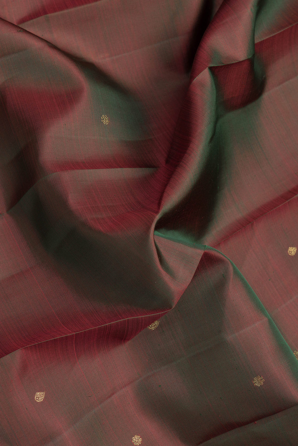 Close up of Mehandi Green Dual Tone Kanjivaram Silk Saree with Zari Butta on the body and Zari Border.  displaying folds