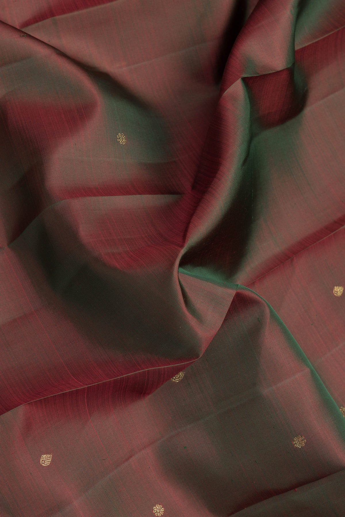 Close up of Mehandi Green Dual Tone Kanjivaram Silk Saree with Zari Butta on the body and Zari Border.  displaying folds