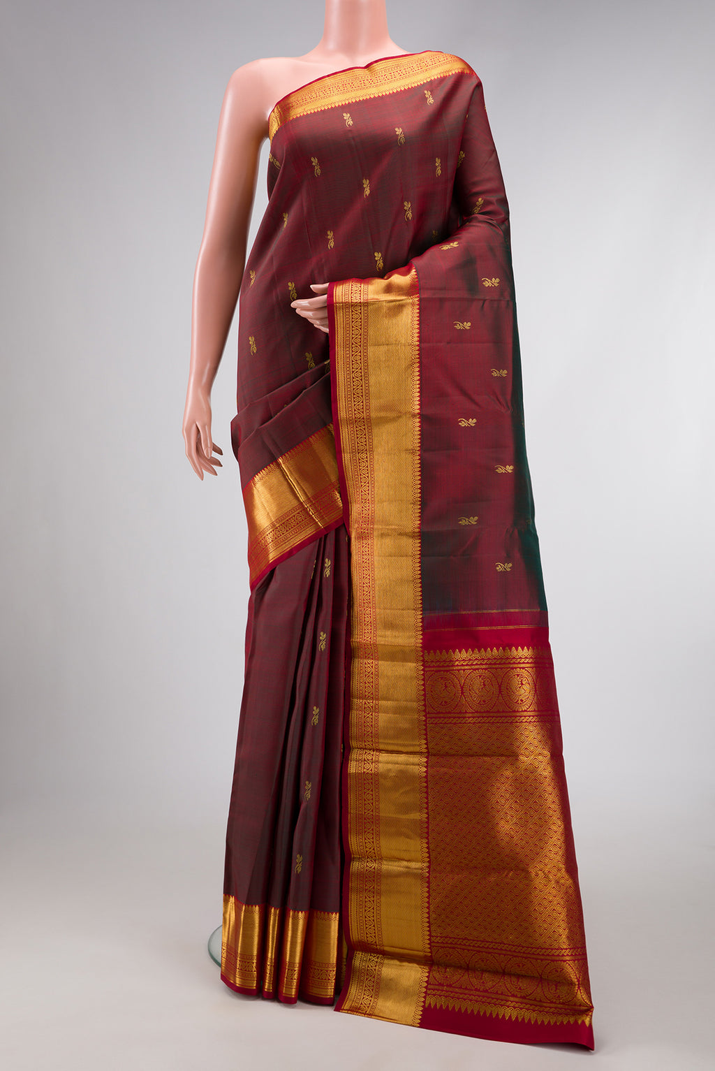 Maroon Dual Tone Kanjivaram Silk Saree with Zari Butta on the body and Zari Border.  displayed on a mannequin