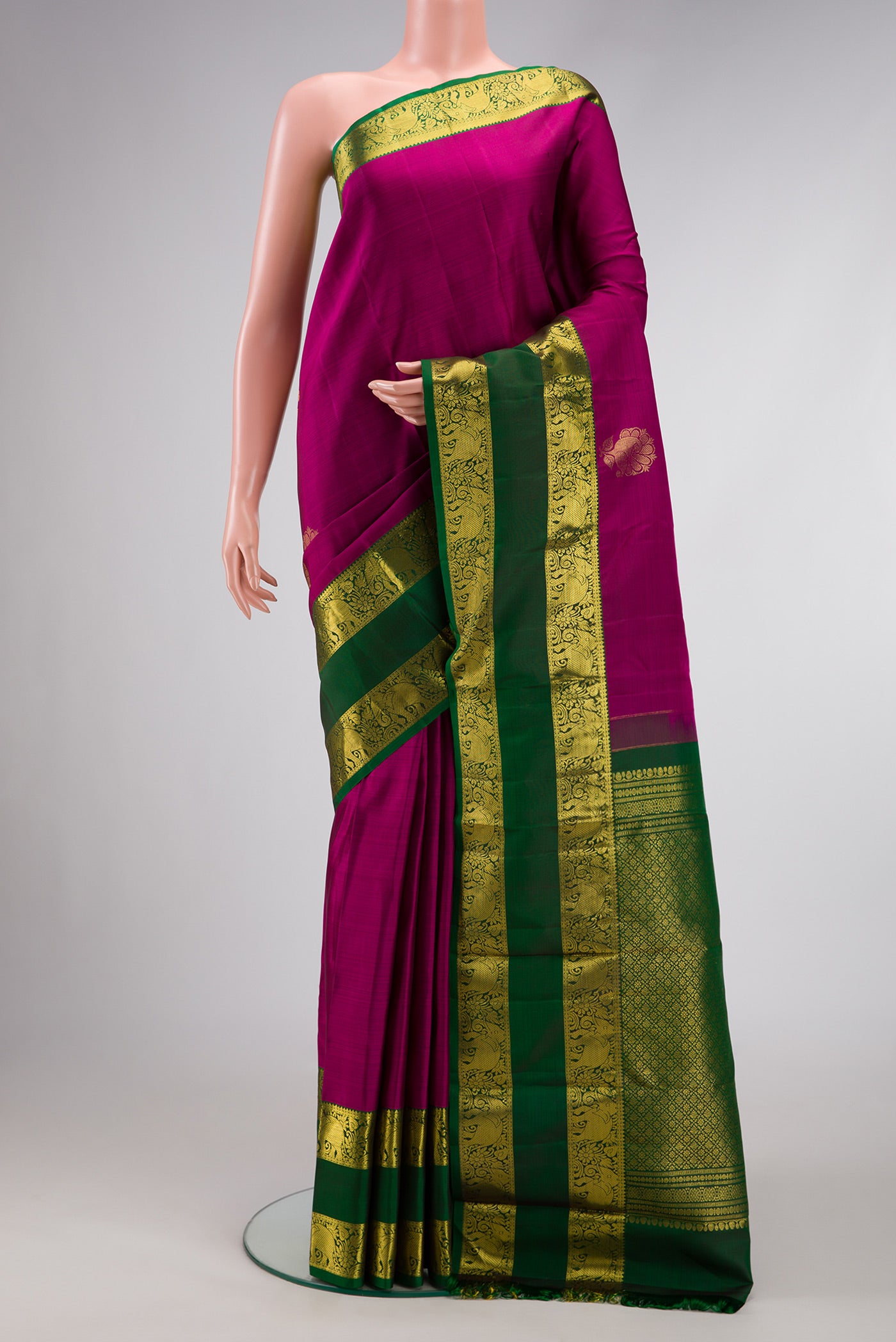 Magenta Dual Tone Kanchipuram Silk Saree with Zari Butta on the body and Zari Border.  displayed on a mannequin