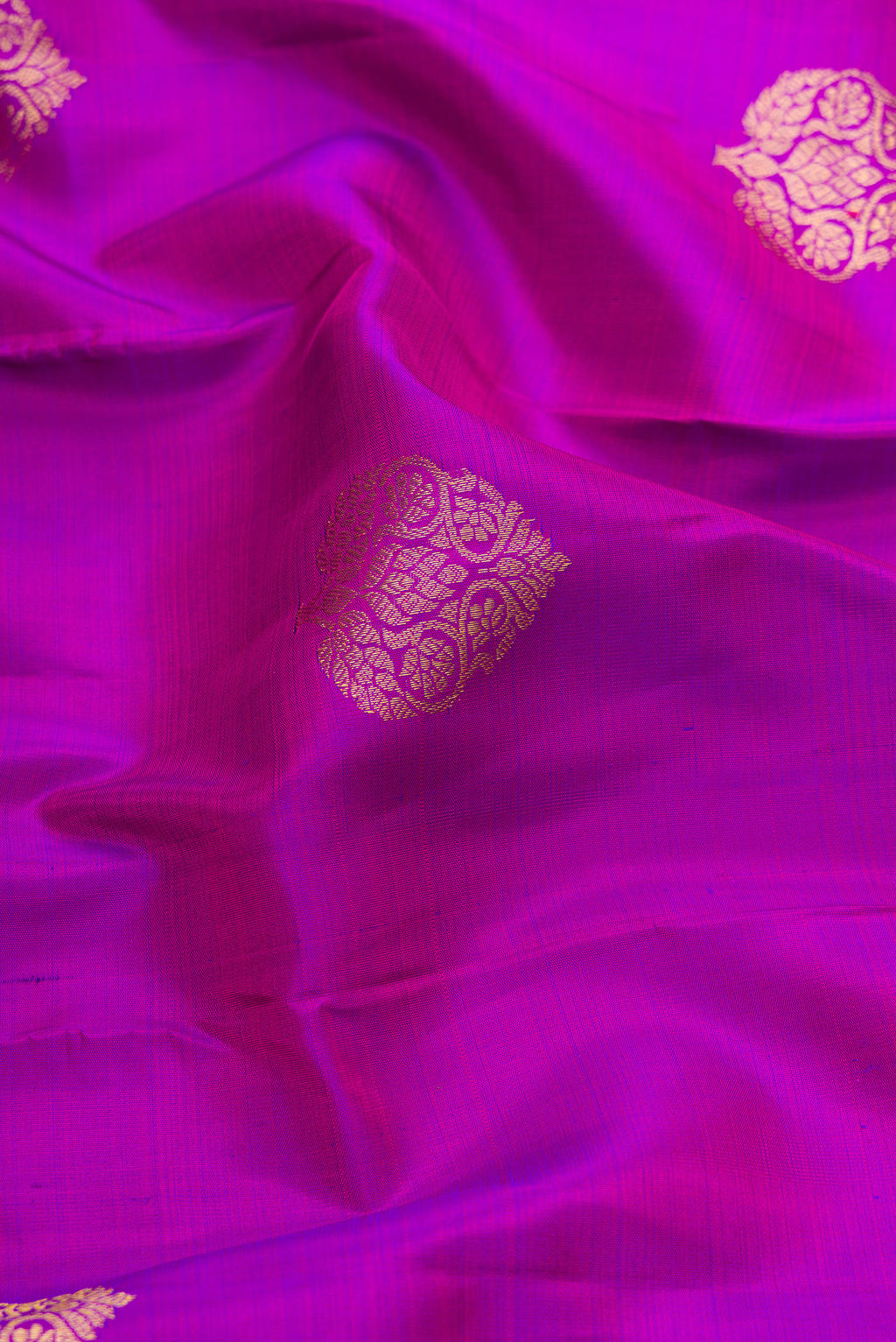 Close up of Purple Dual Tone Kanjivaram Silk Saree with Zari Butta on the body and Zari Border.  displaying folds