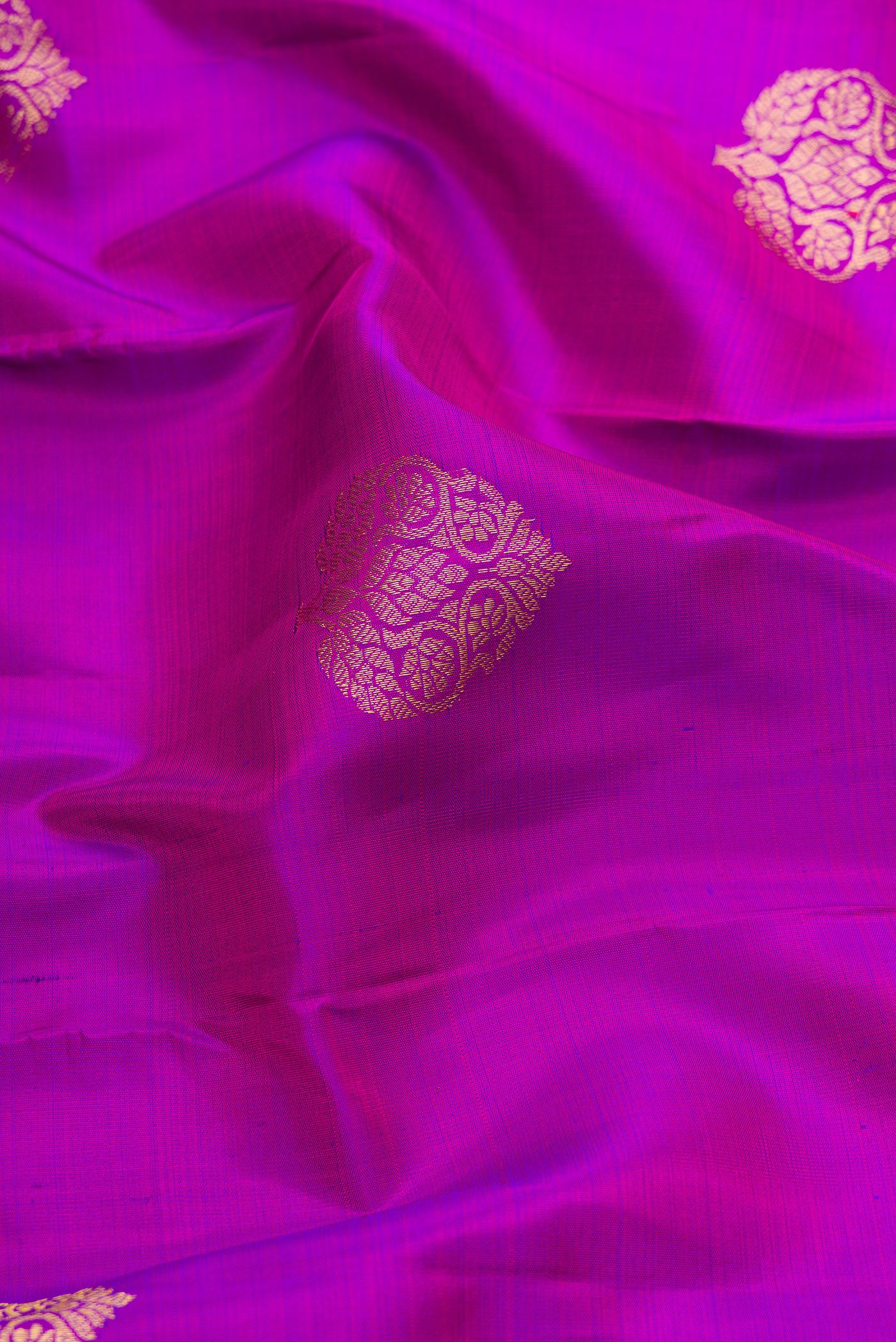 Close up of Purple Dual Tone Kanjivaram Silk Saree with Zari Butta on the body and Zari Border.  displaying folds