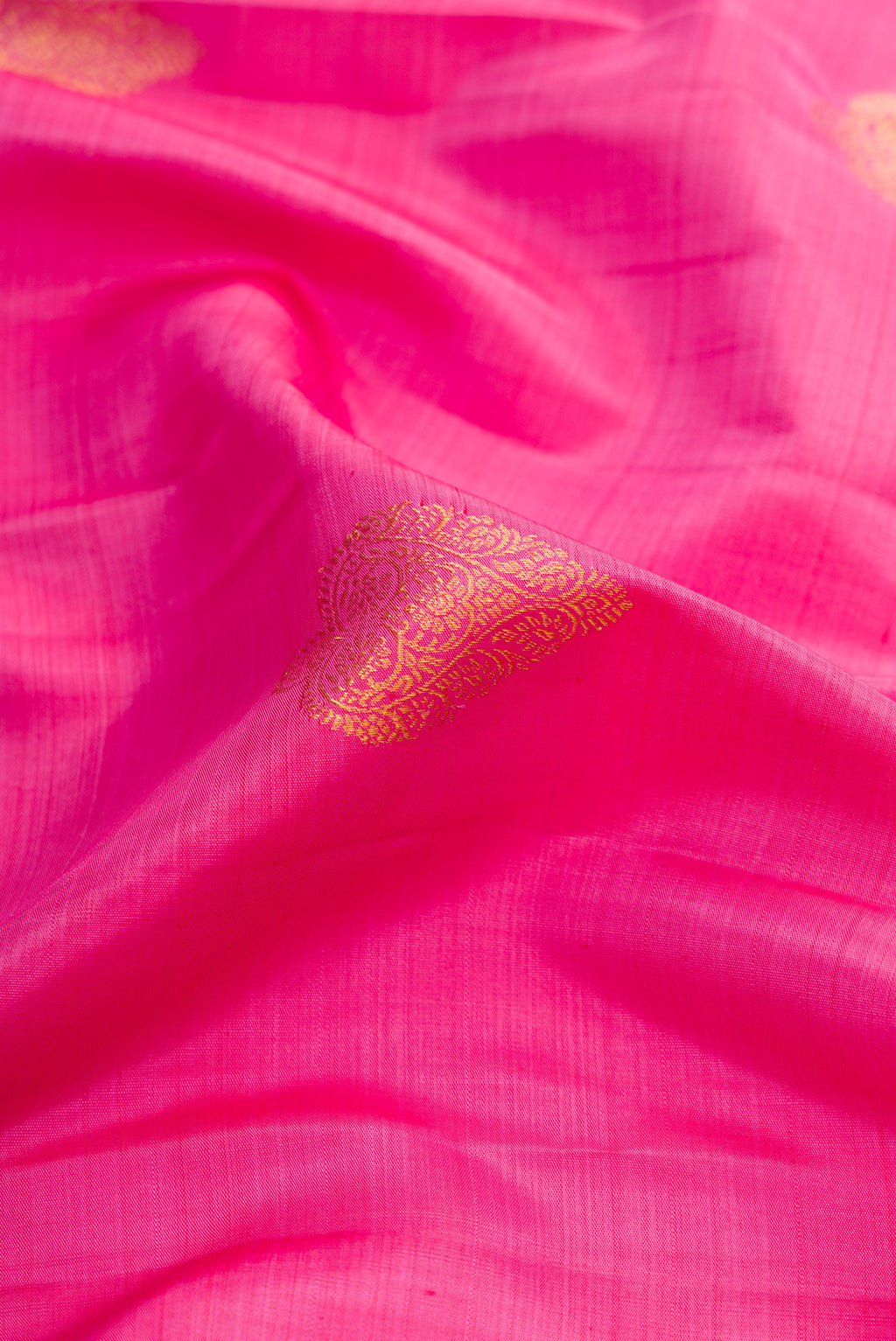 Close up of Pink Dual Tone Kanjivaram Silk Saree with Zari Butta on the body and Zari Border.  displaying folds