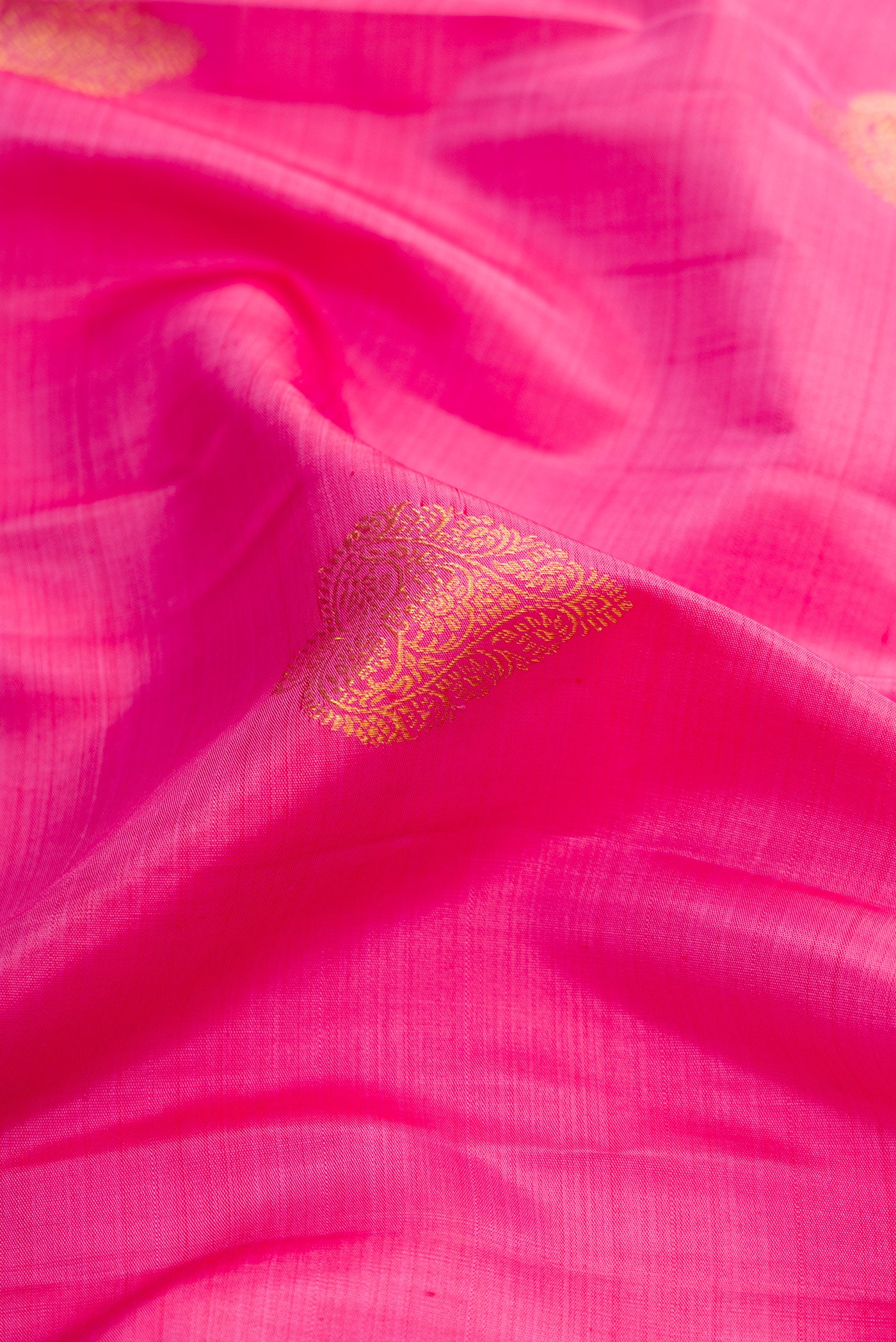 Close up of Pink Dual Tone Kanjivaram Silk Saree with Zari Butta on the body and Zari Border.  displaying folds