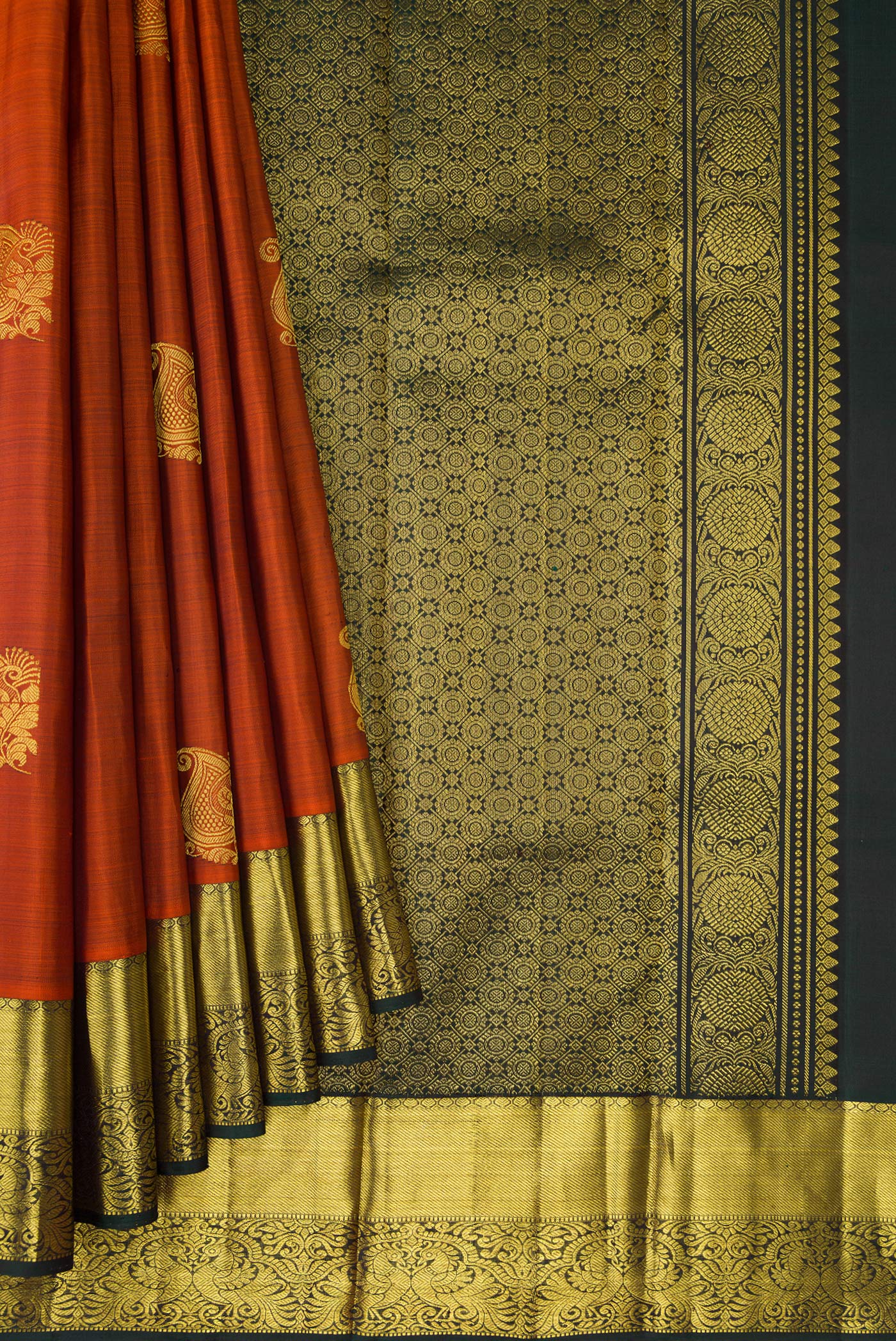 Pleats and pallu of Brick Orange Dual Tone Kanjivaram Silk Saree with Zari Butta on the body and Zari Border. 