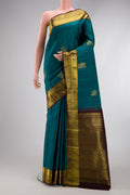 Teal Dual Tone Kanjivaram Silk Saree with Zari Butta on the body and Zari Border.  displayed on a mannequin