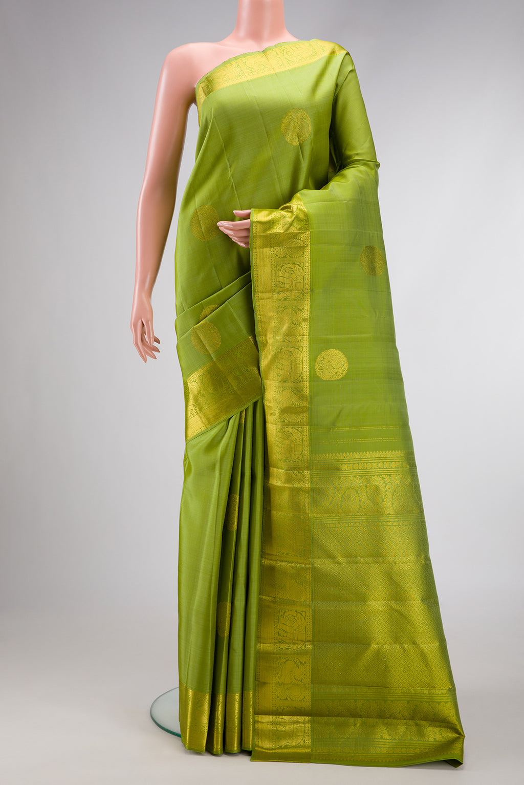 Green Dual Tone Kanjivaram Silk Saree with Zari Butta on the body and Zari Border.  displayed on a mannequin