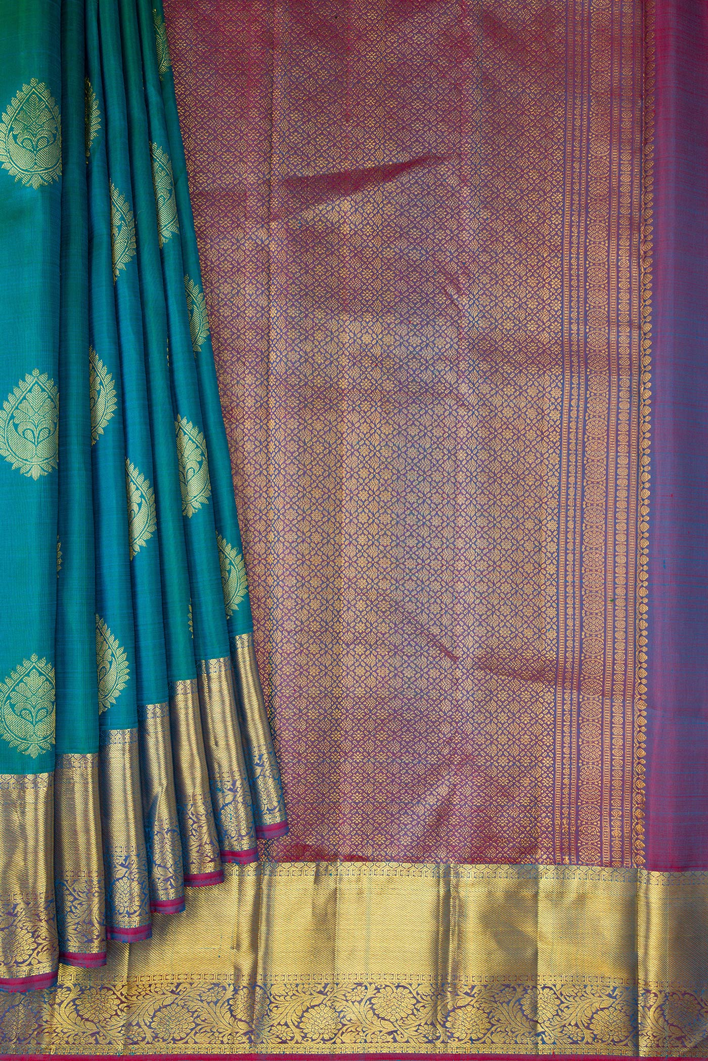 Pleats and pallu of Peacock Blue Dual Tone Kanjivaram Silk Saree with Zari Butta on the body and Zari Border. 