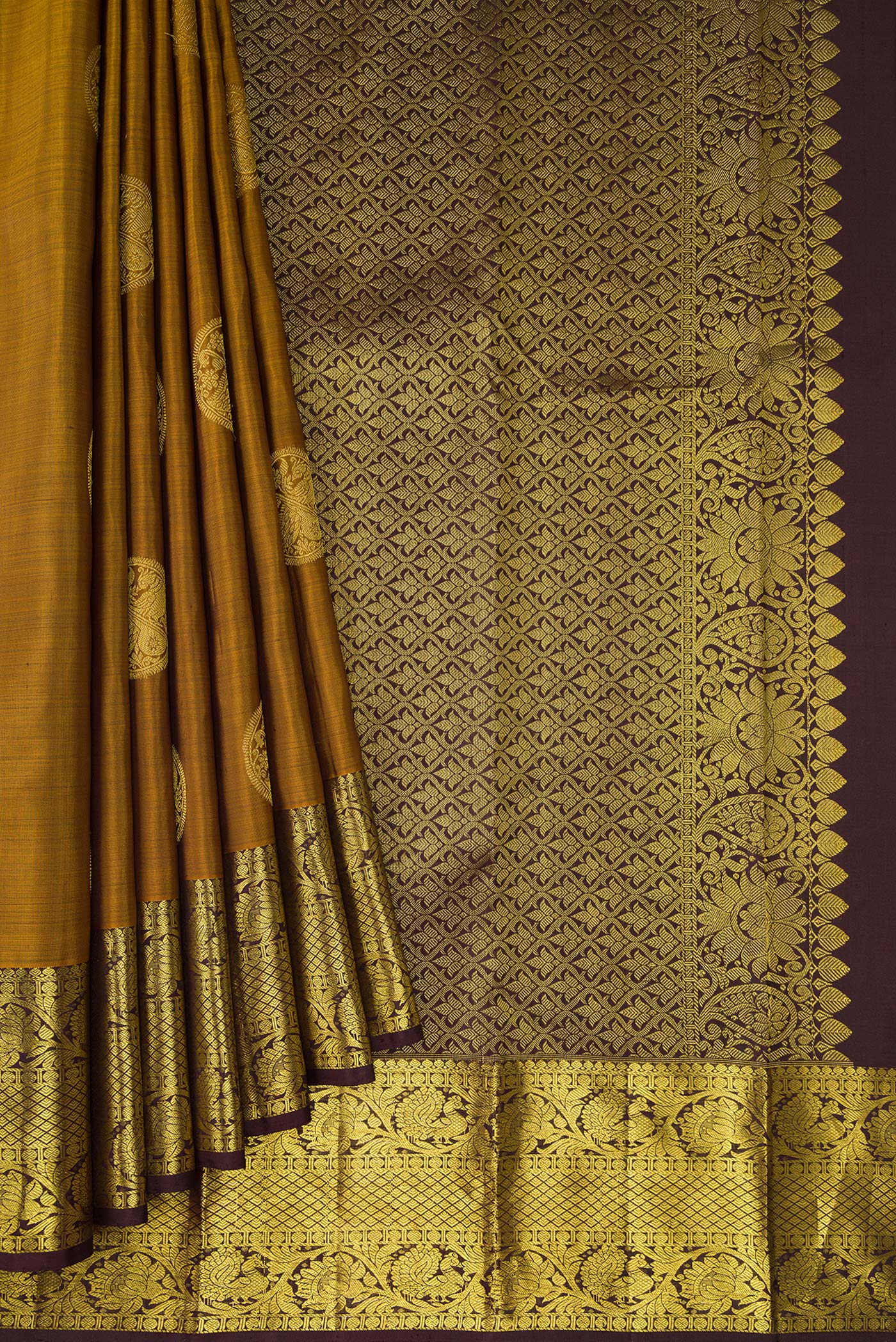 Pleats and pallu of Gold Dual Tone Kanjivaram Silk Saree with Zari Butta on the body and Zari Border. 