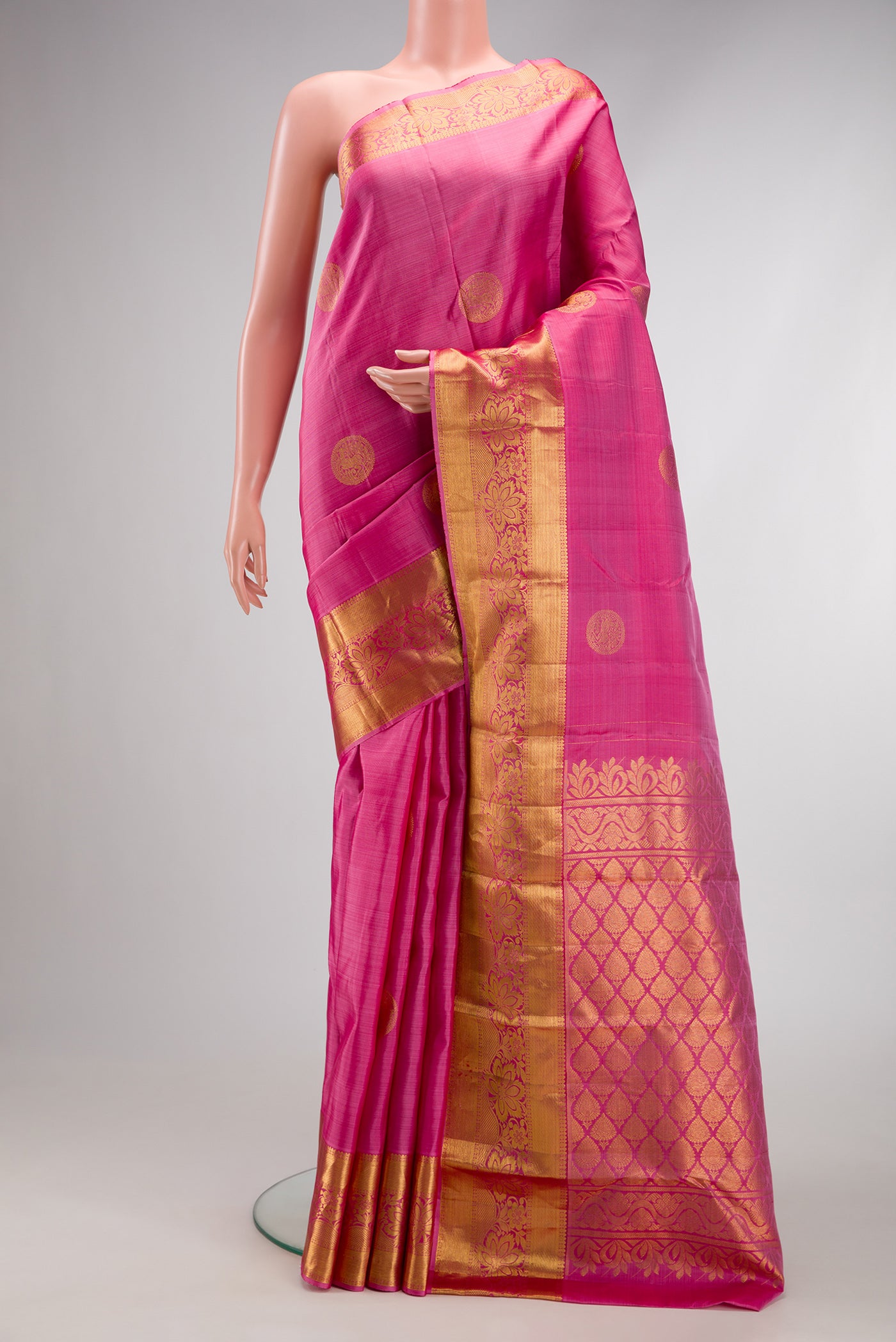 Pink Kanjivaram Silk Saree with Zari Butta on the body and Zari Border.  displayed on a mannequin