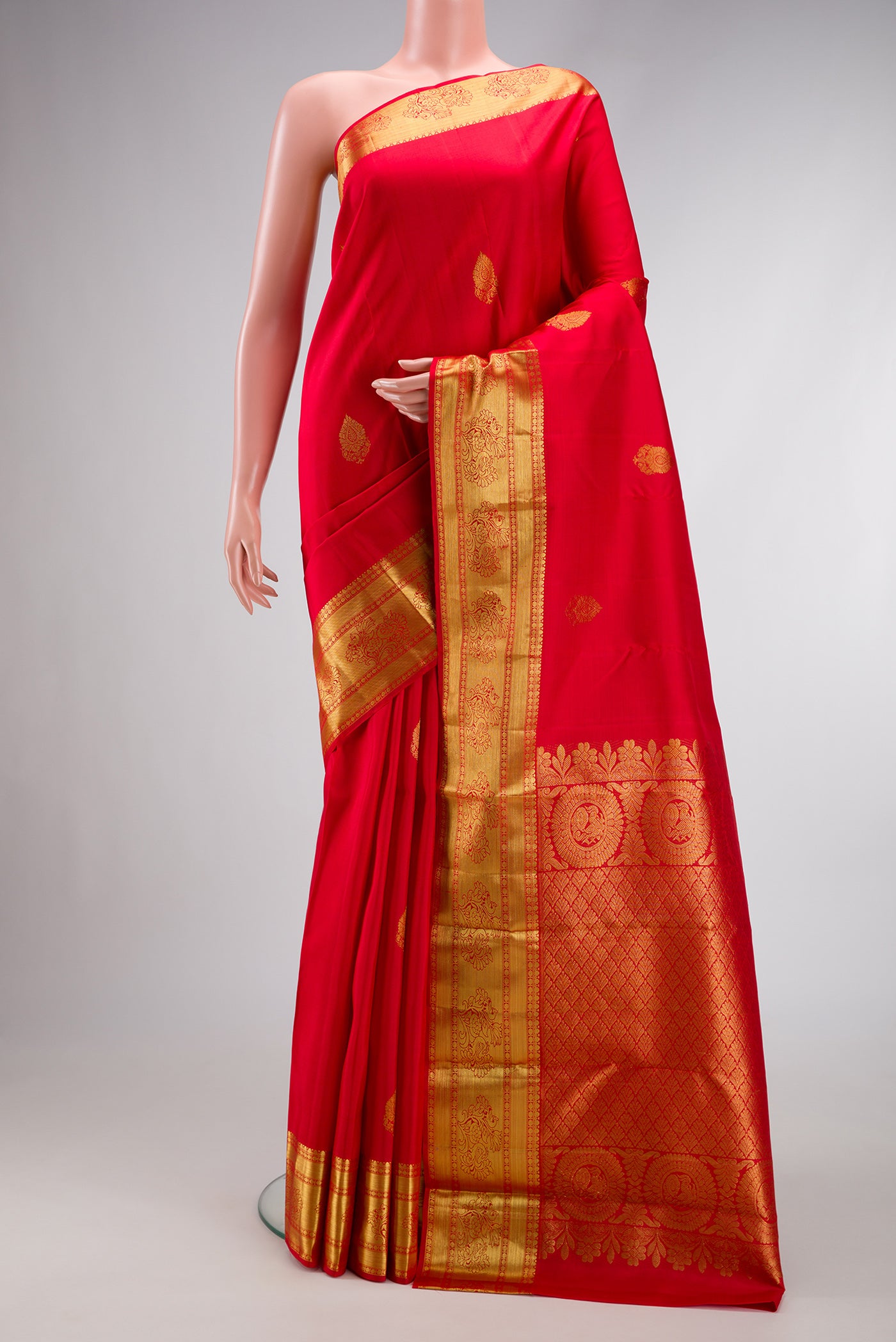 Red Dual Tone Kanjivaram Silk Saree with Zari Butta on the body and Zari Border.  displayed on a mannequin
