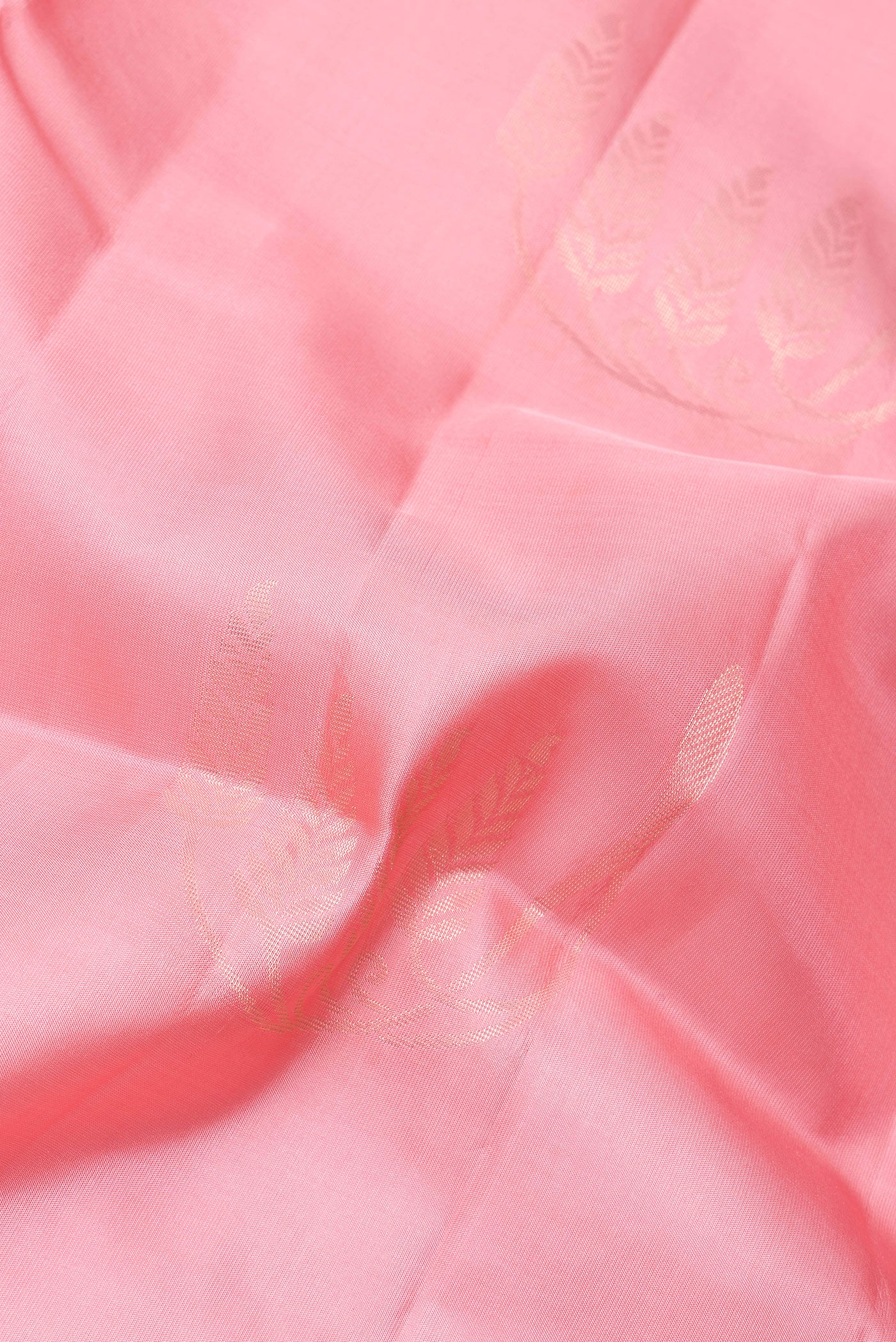 Close up of Rose pink Soft Silk Saree with Zari Butta on the body and Zari Border.  displaying folds