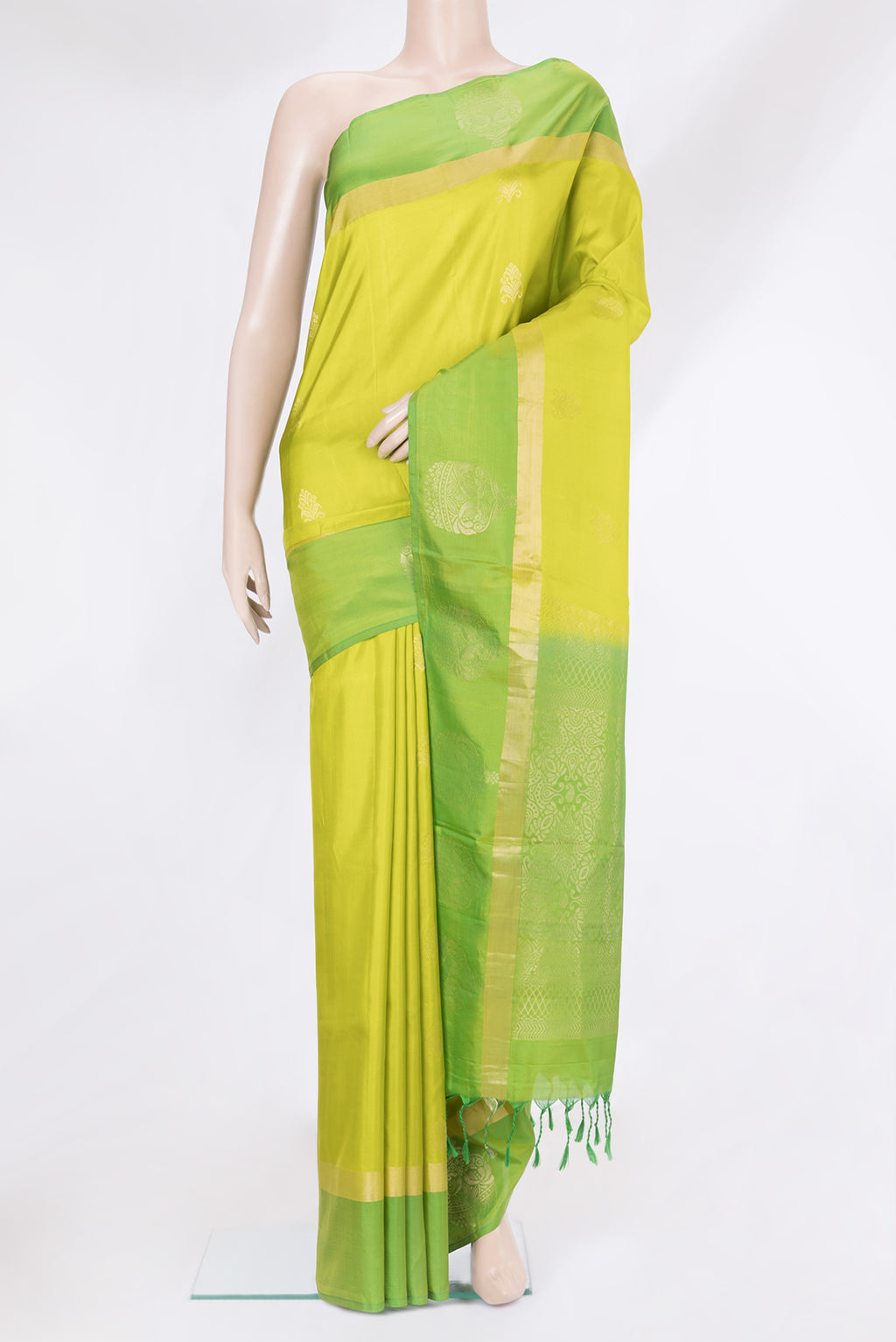 Parrot Green Soft Silk Saree with Zari Butta on the body and Fancy Border.  displayed on a mannequin