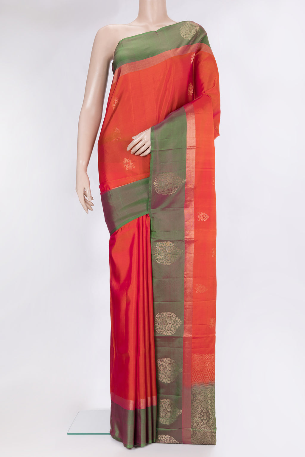 Brick Orange Soft Silk Saree with Zari Butta on the body and Fancy Border.  displayed on a mannequin