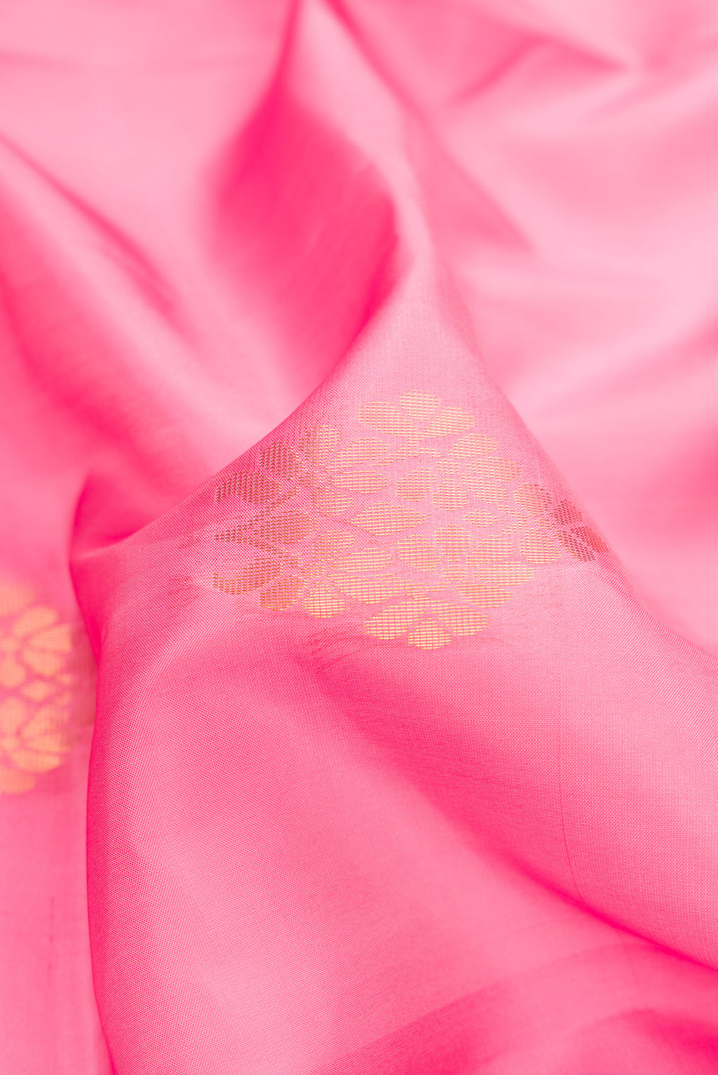 Close up of Pink Dual Tone Soft Silk Saree with Zari Butta on the body and Fancy Border.  displaying folds