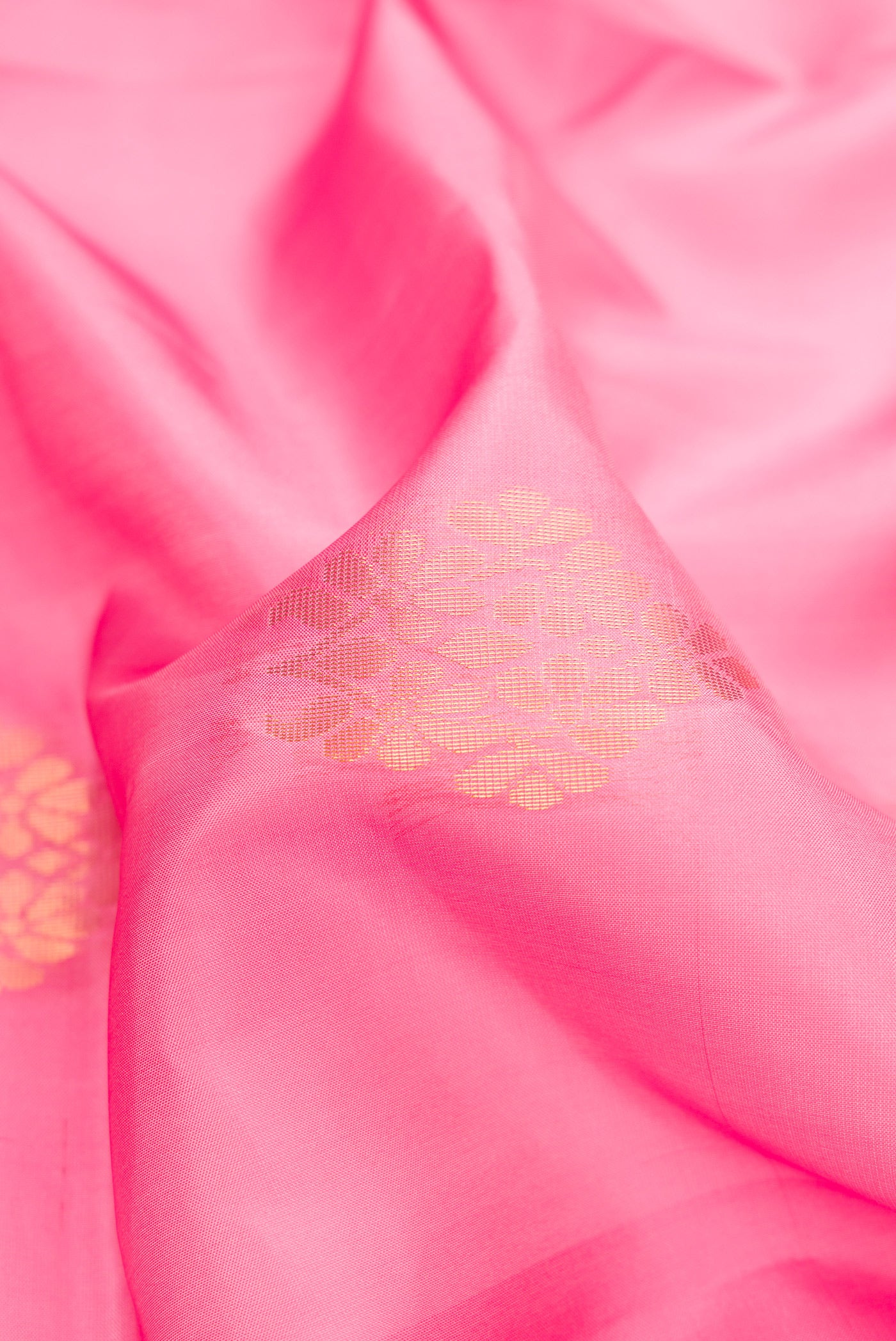 Close up of Pink Dual Tone Soft Silk Saree with Zari Butta on the body and Fancy Border.  displaying folds