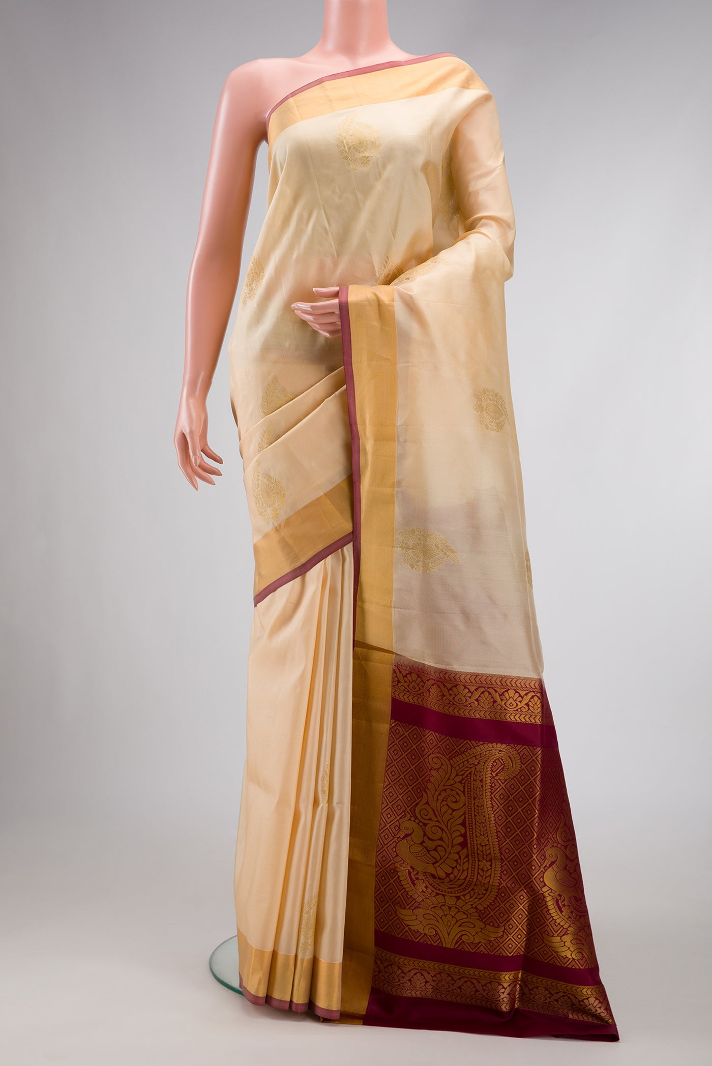 Sandal Dual Tone Soft Silk Saree with Zari Butta on the body and Zari Border.  displayed on a mannequin