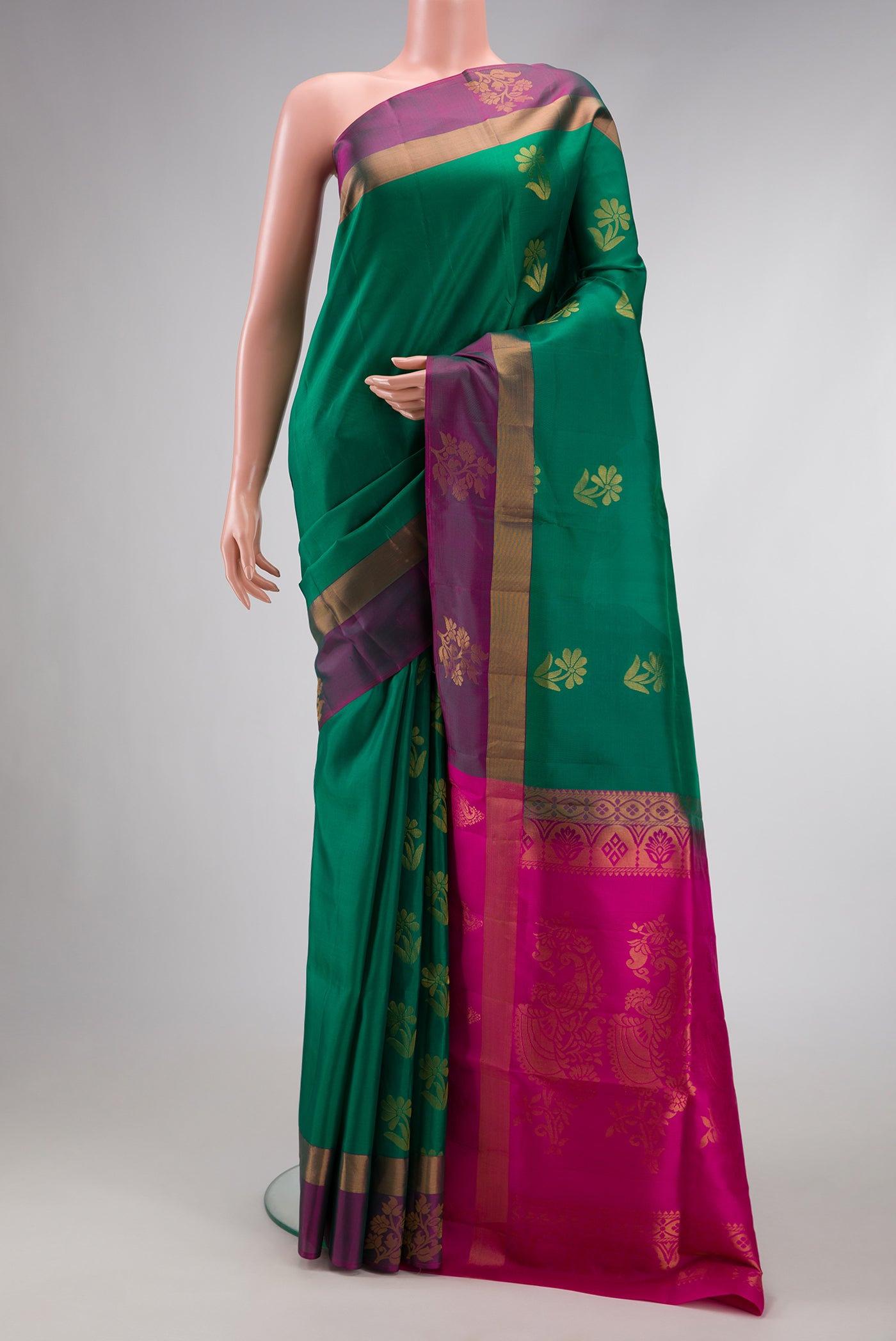 Green Dual Tone Soft Silk Saree with Zari Butta on the body and Fancy Border.  displayed on a mannequin
