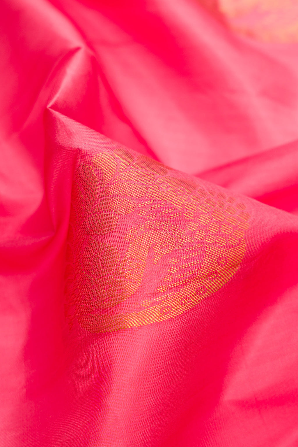 Close up of Pink Dual Tone Soft Silk Saree with Zari Butta on the body and Zari Border.  displaying folds