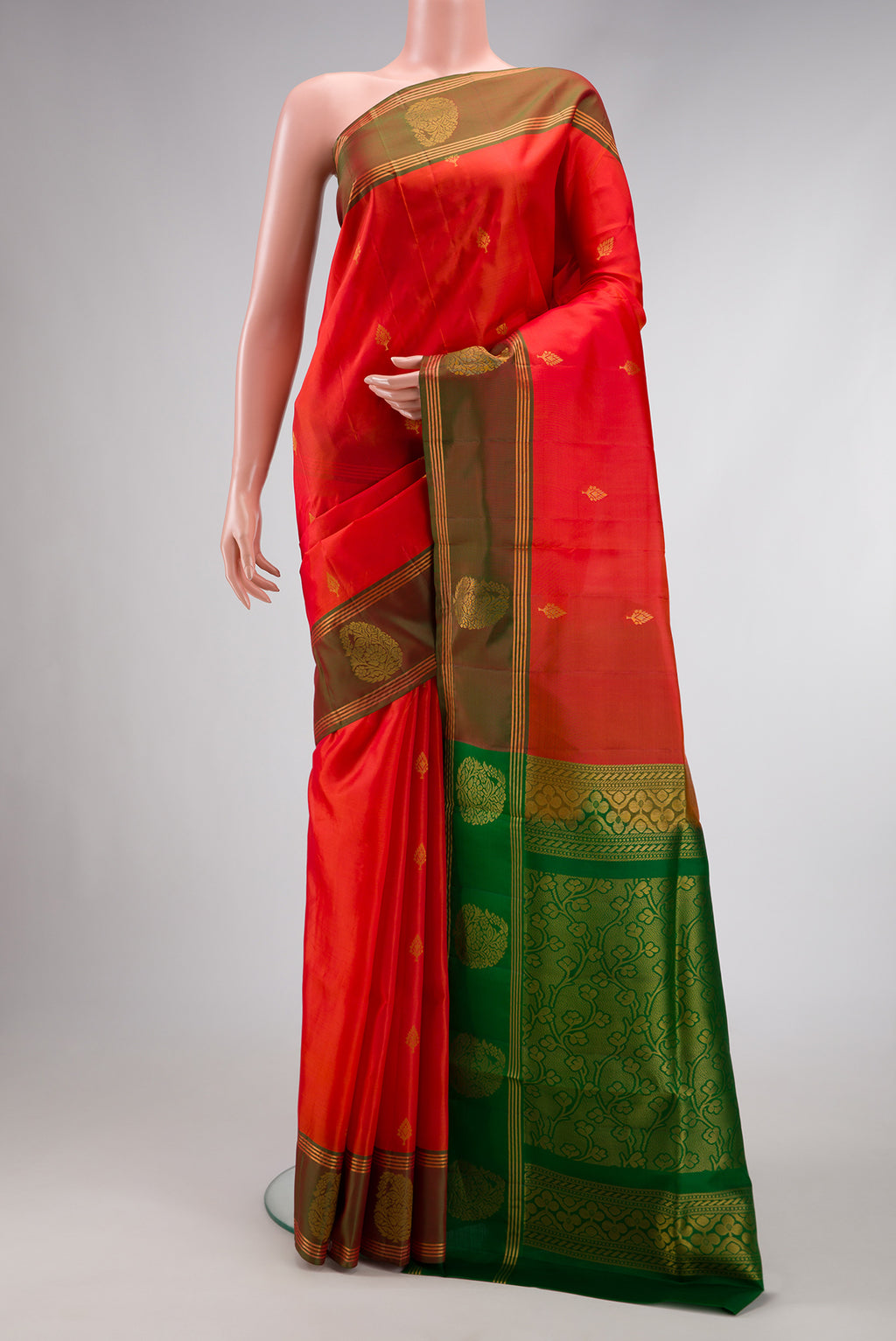 Brick Orange Dual Tone Soft Silk Saree with Zari Butta on the body and Fancy Border.  displayed on a mannequin