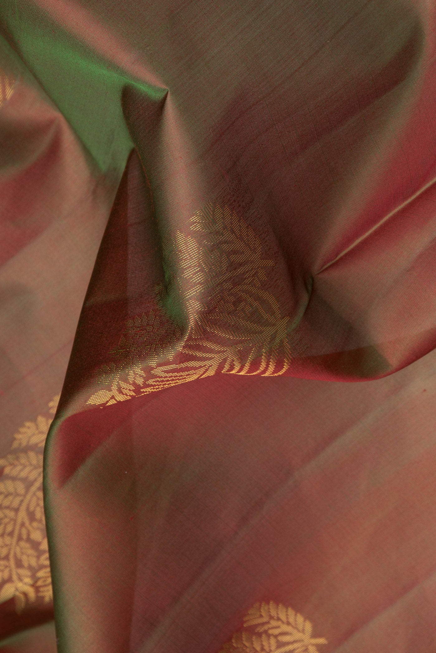 Close up of Mehandi Green Dual Tone Soft Silk Saree with Zari Butta on the body and Zari Border.  displaying folds