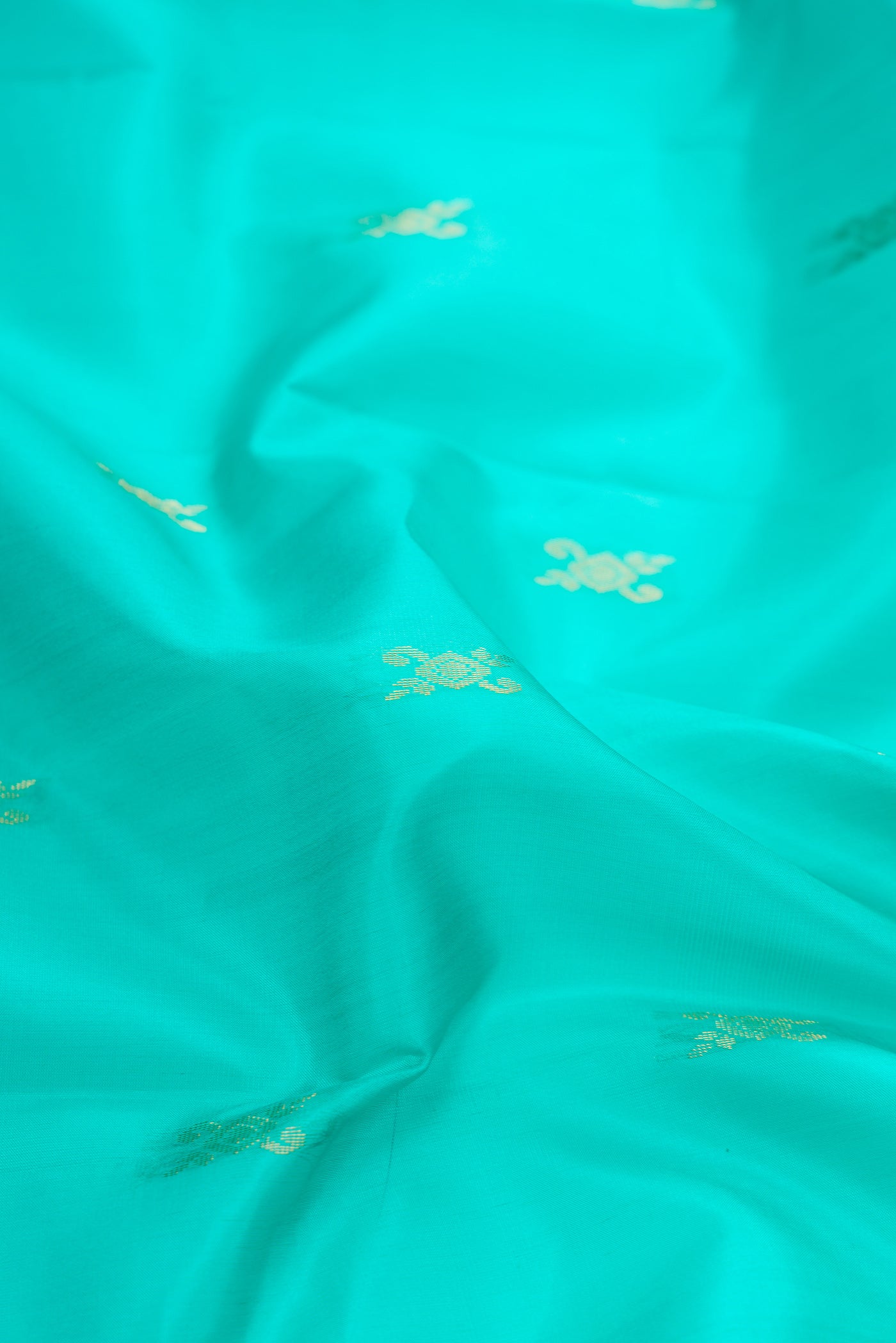 Close up of Sky Blue Dual Tone Soft Silk Saree with Zari Butta on the body and Fancy Border.  displaying folds