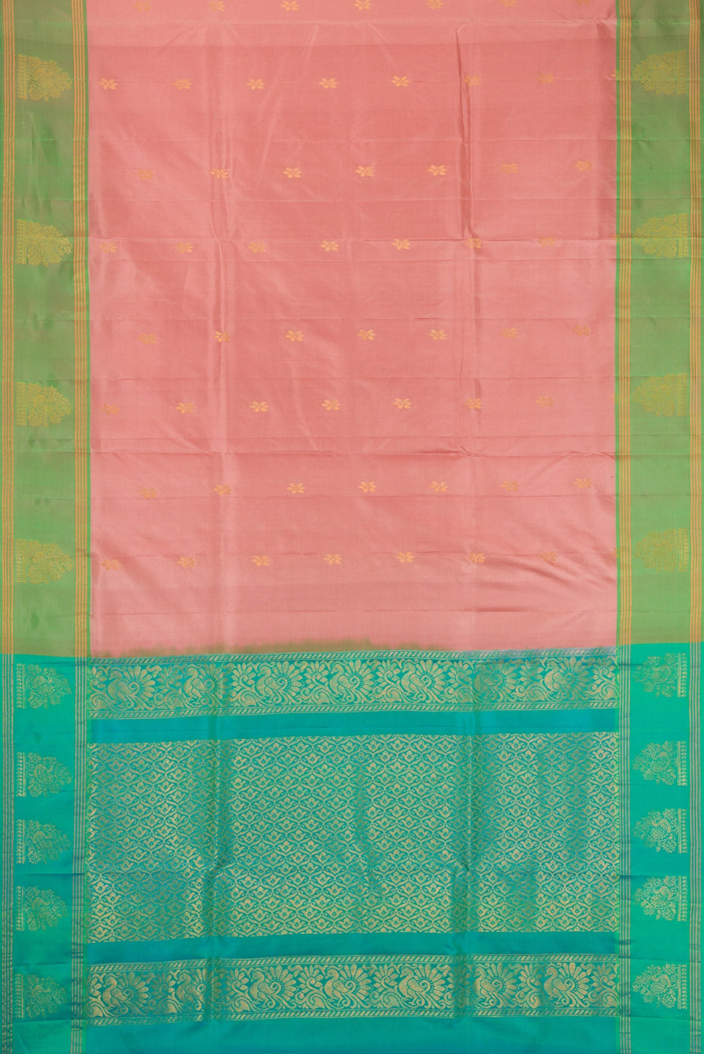 Rose Gold Soft Silk Saree with Zari Butta on the body and Fancy Border.  displayed on a mannequin