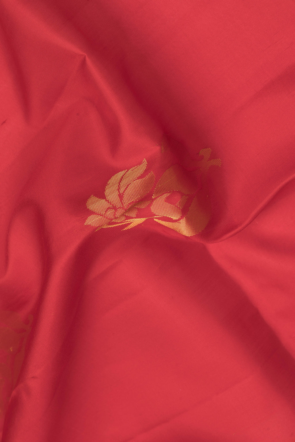 Close up of Red Dual Tone Soft Silk Saree with Zari Butta on the body and Zari Border.  displaying folds