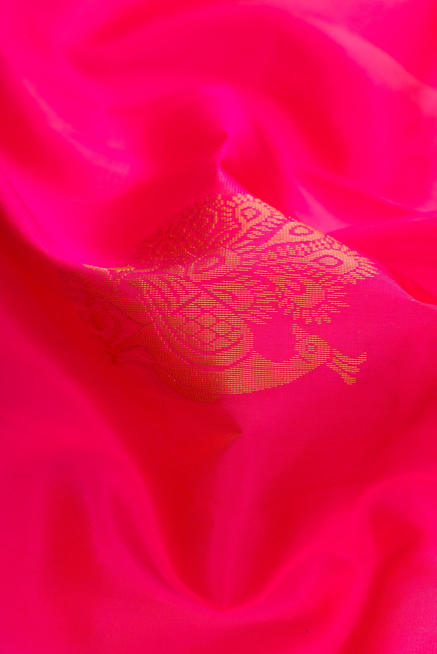 Close up of Pink Soft Silk Saree with Zari Butta on the body and Zari Border.  displaying folds