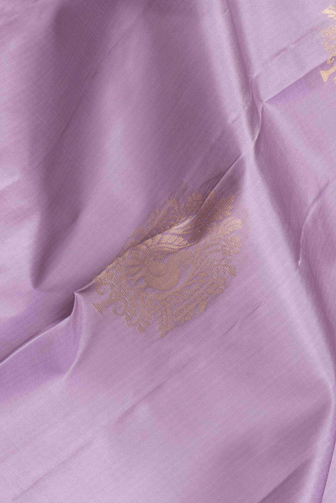 Close up of Lavender Dual Tone Soft Silk Saree with Zari Butta on the body and Zari Border.  displaying folds