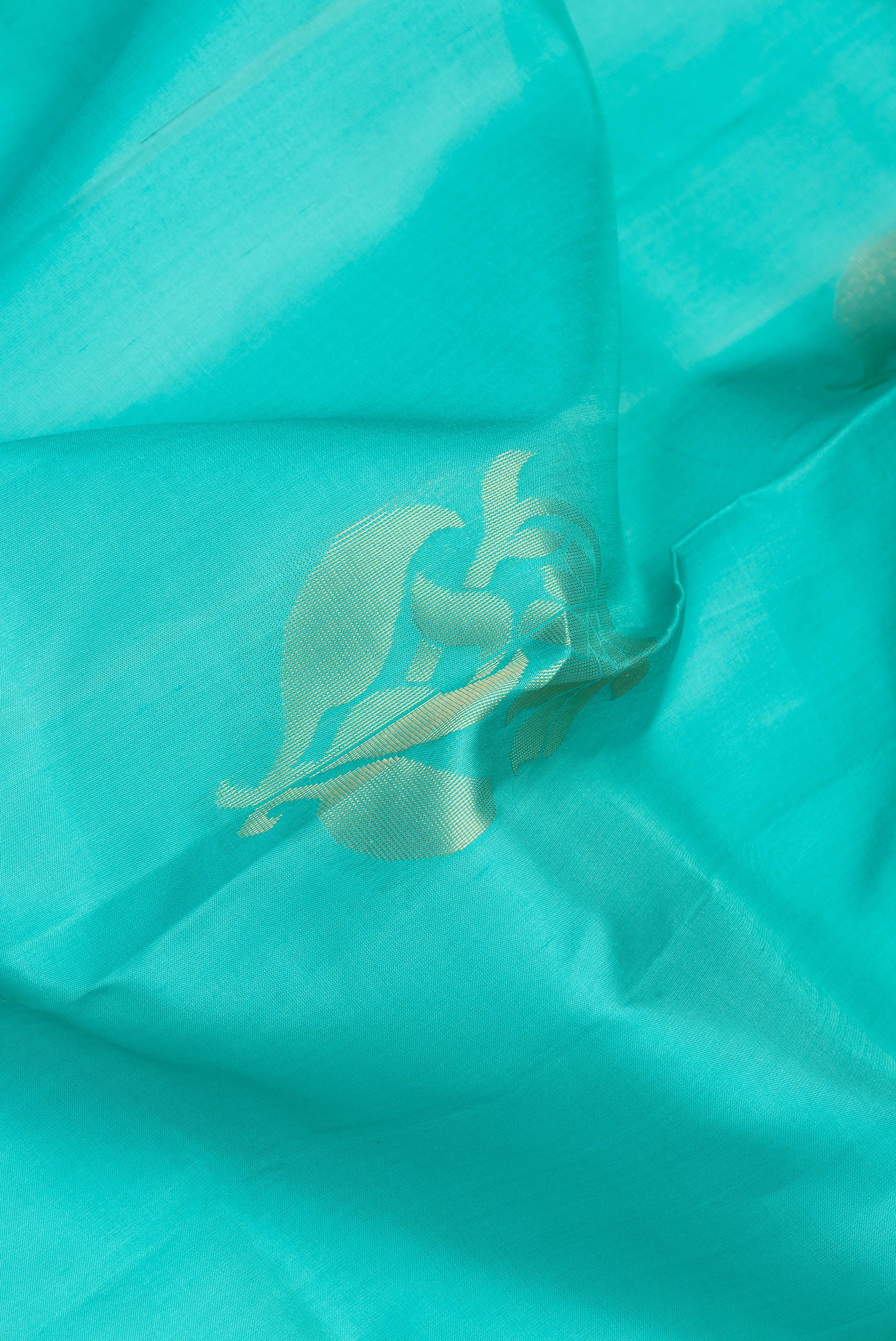 Close up of Sea Green Dual Tone Soft Silk Saree with Zari Butta on the body and Zari Border.  displaying folds