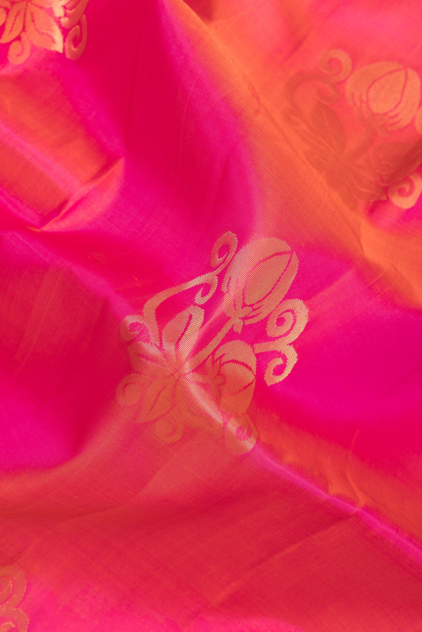 Close up of Dark Pink Soft Silk Saree with Zari Butta on the body and Zari Border.  displaying folds