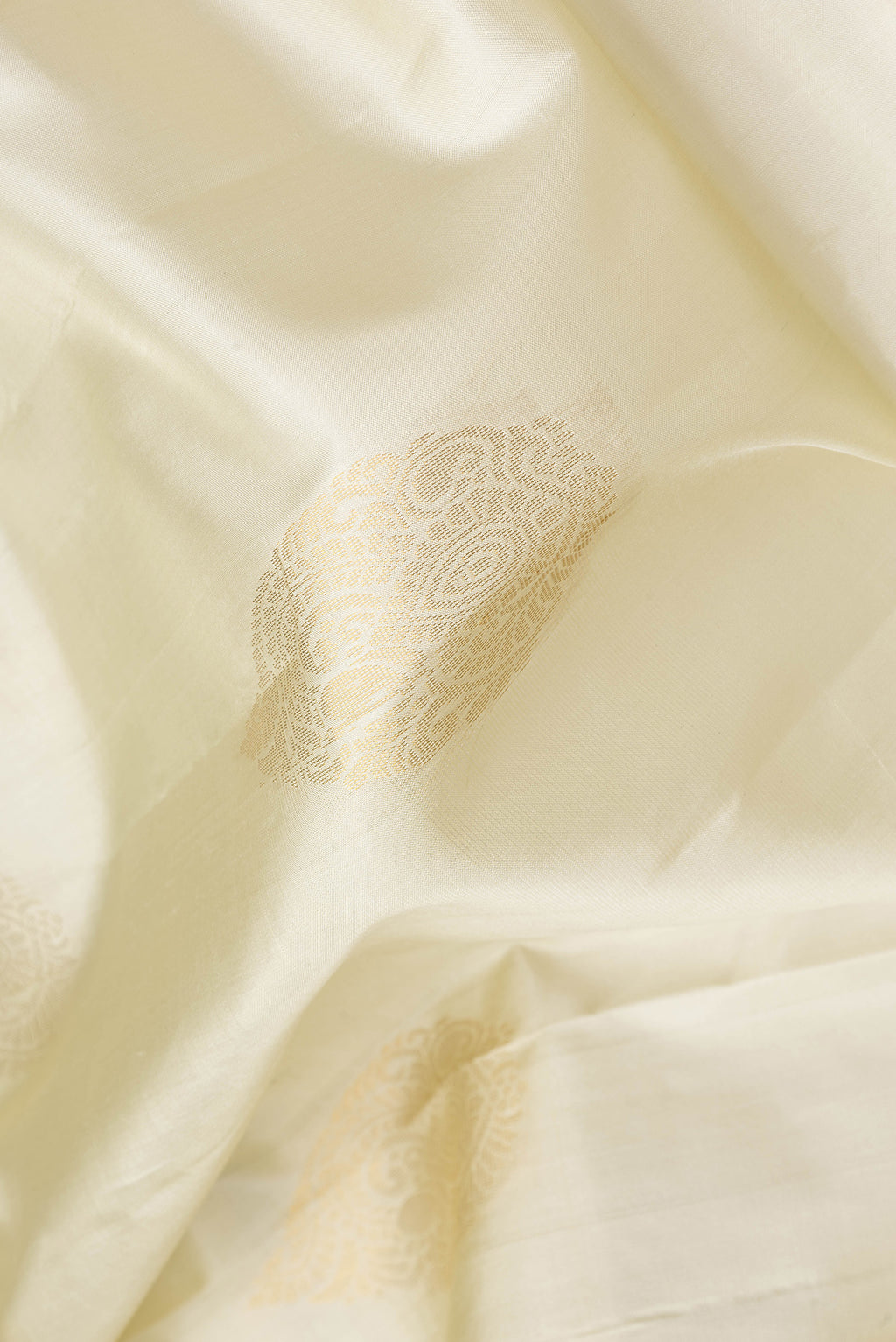 Close up of Pista Green Dual Tone Soft Silk Saree with Zari Butta on the body and Zari Border.  displaying folds