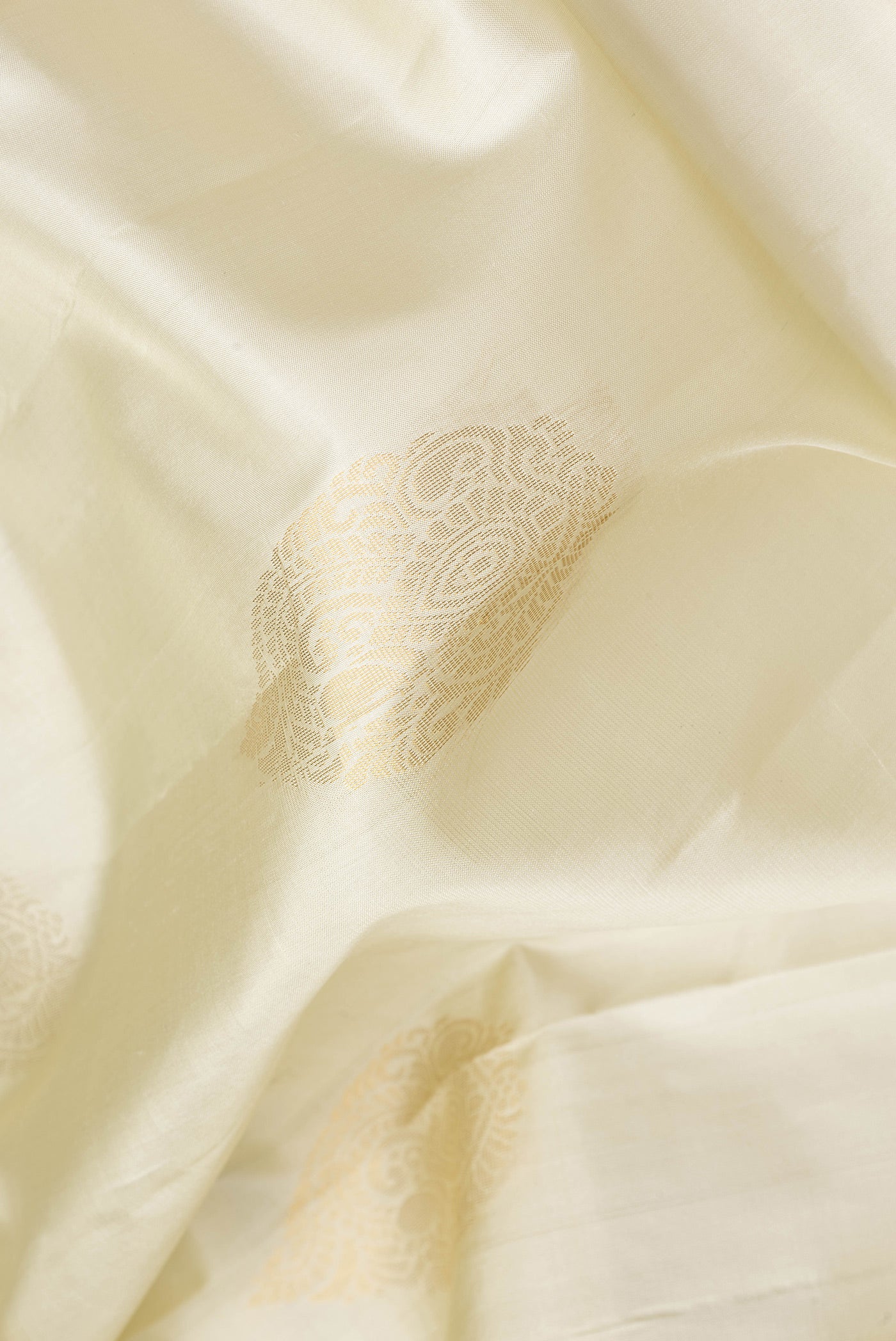 Close up of Pista Green Dual Tone Soft Silk Saree with Zari Butta on the body and Zari Border.  displaying folds