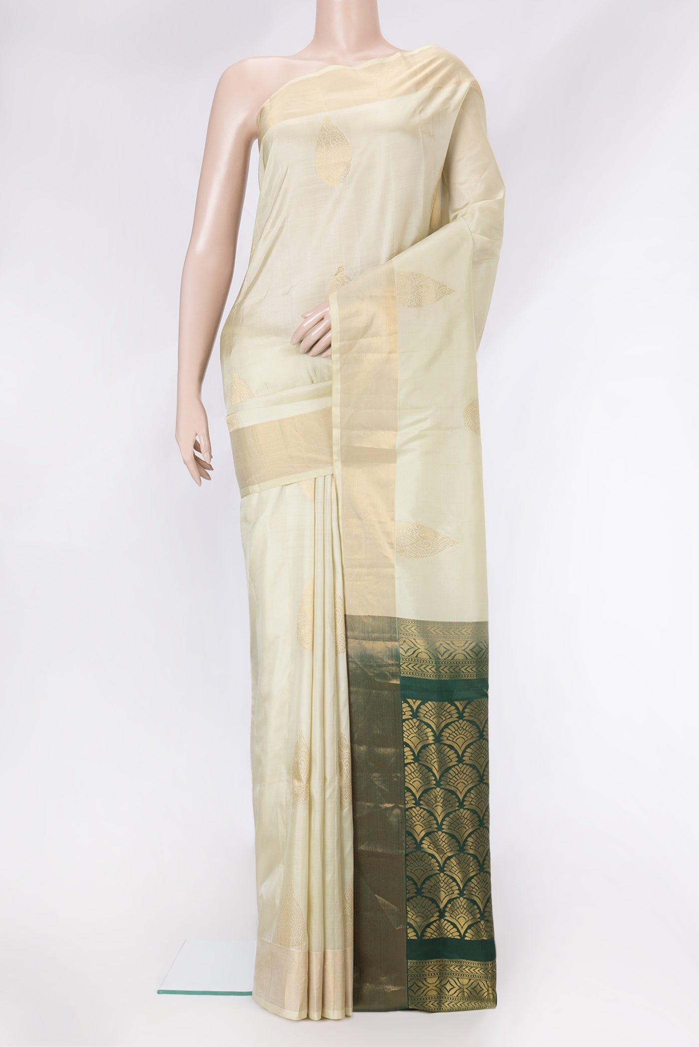 Pista Green Dual Tone Soft Silk Saree with Zari Butta on the body and Zari Border.  displayed on a mannequin