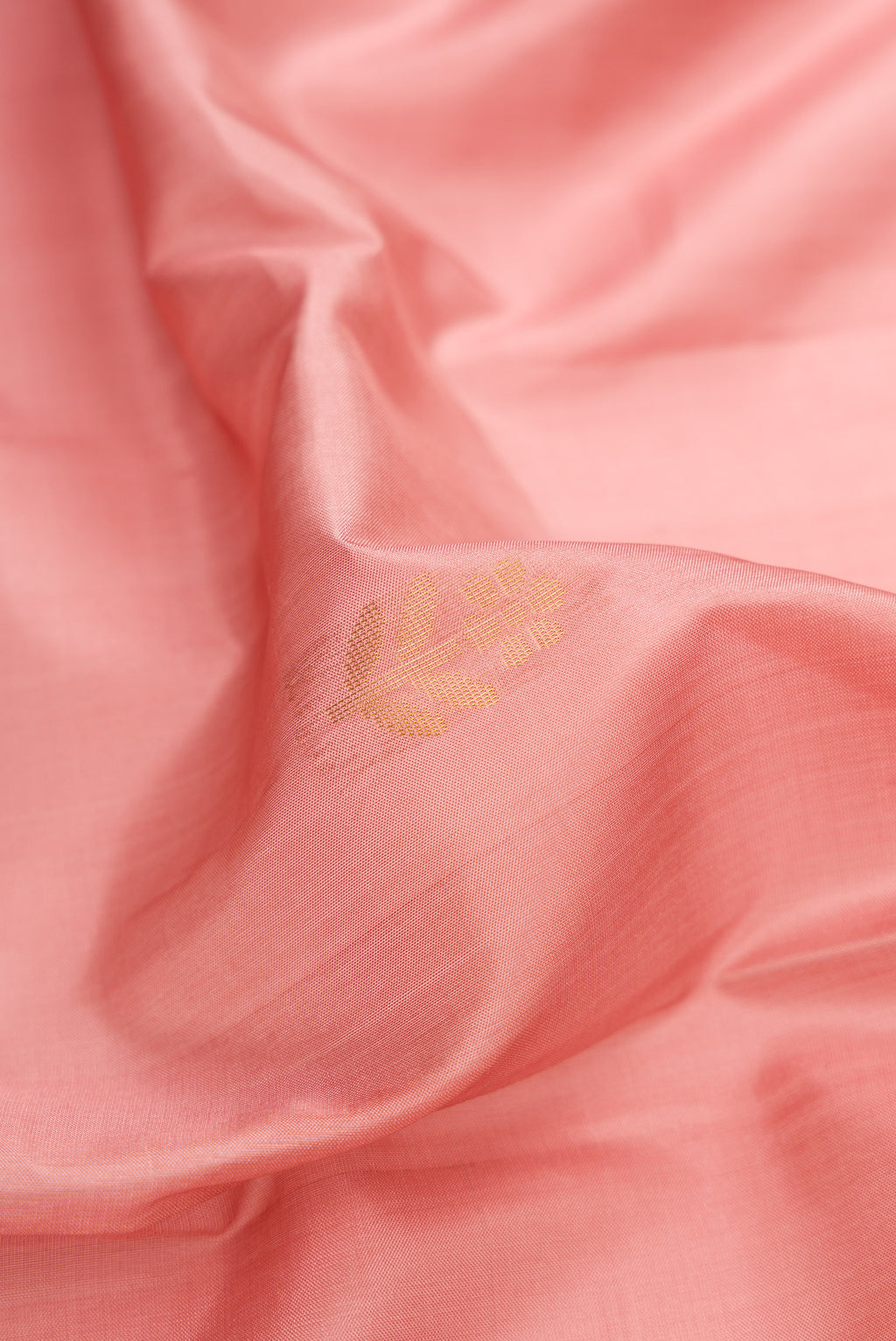 Close up of Rose Gold Dual Tone Soft Silk Saree with Zari Butta on the body and Fancy Border.  displaying folds