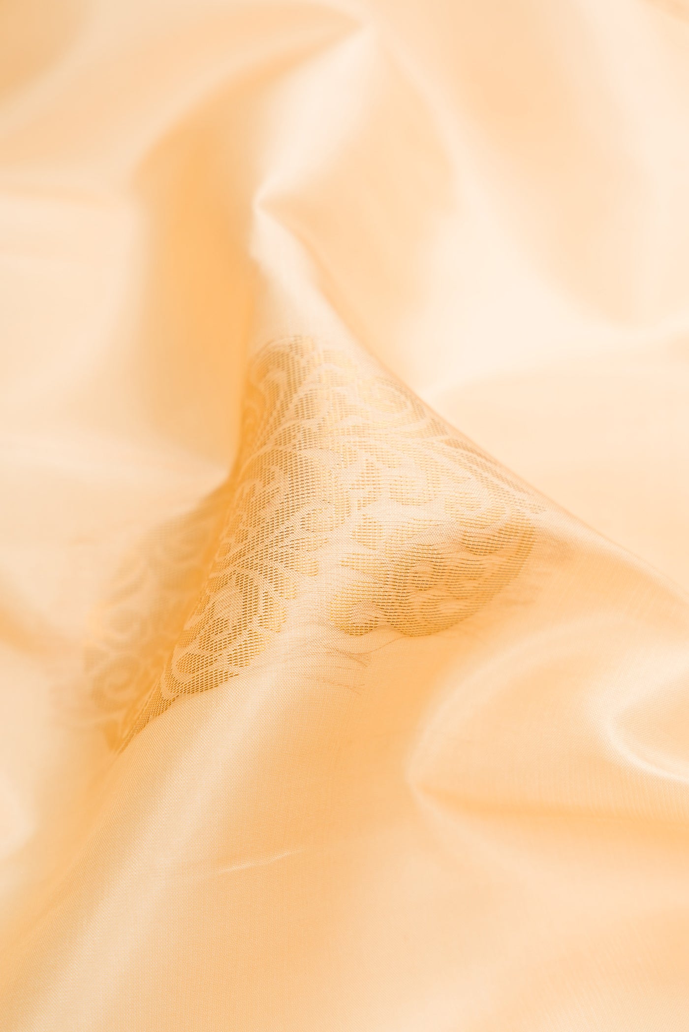 Close up of Sandal Soft Silk Saree with Zari Butta on the body and Zari Border.  displaying folds