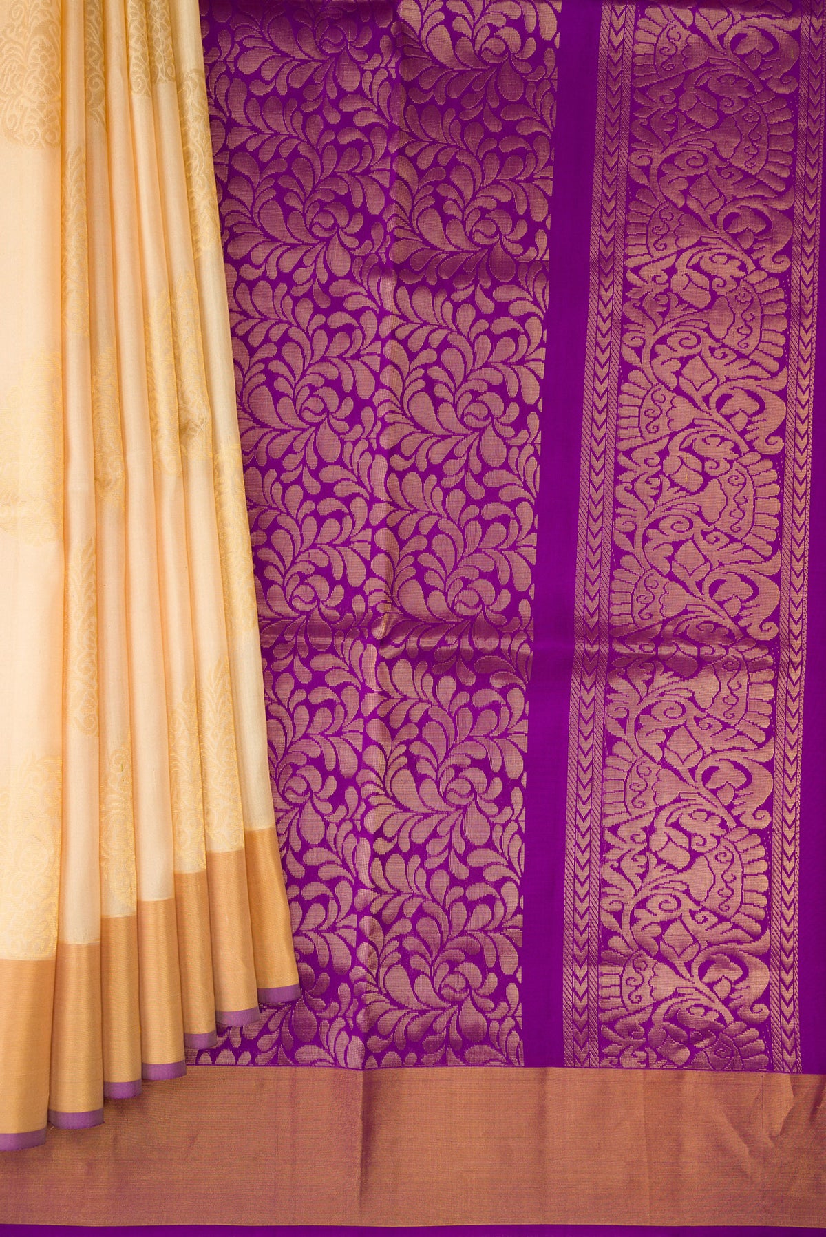 Pleats and pallu of Sandal Soft Silk Saree with Zari Butta on the body and Zari Border. 