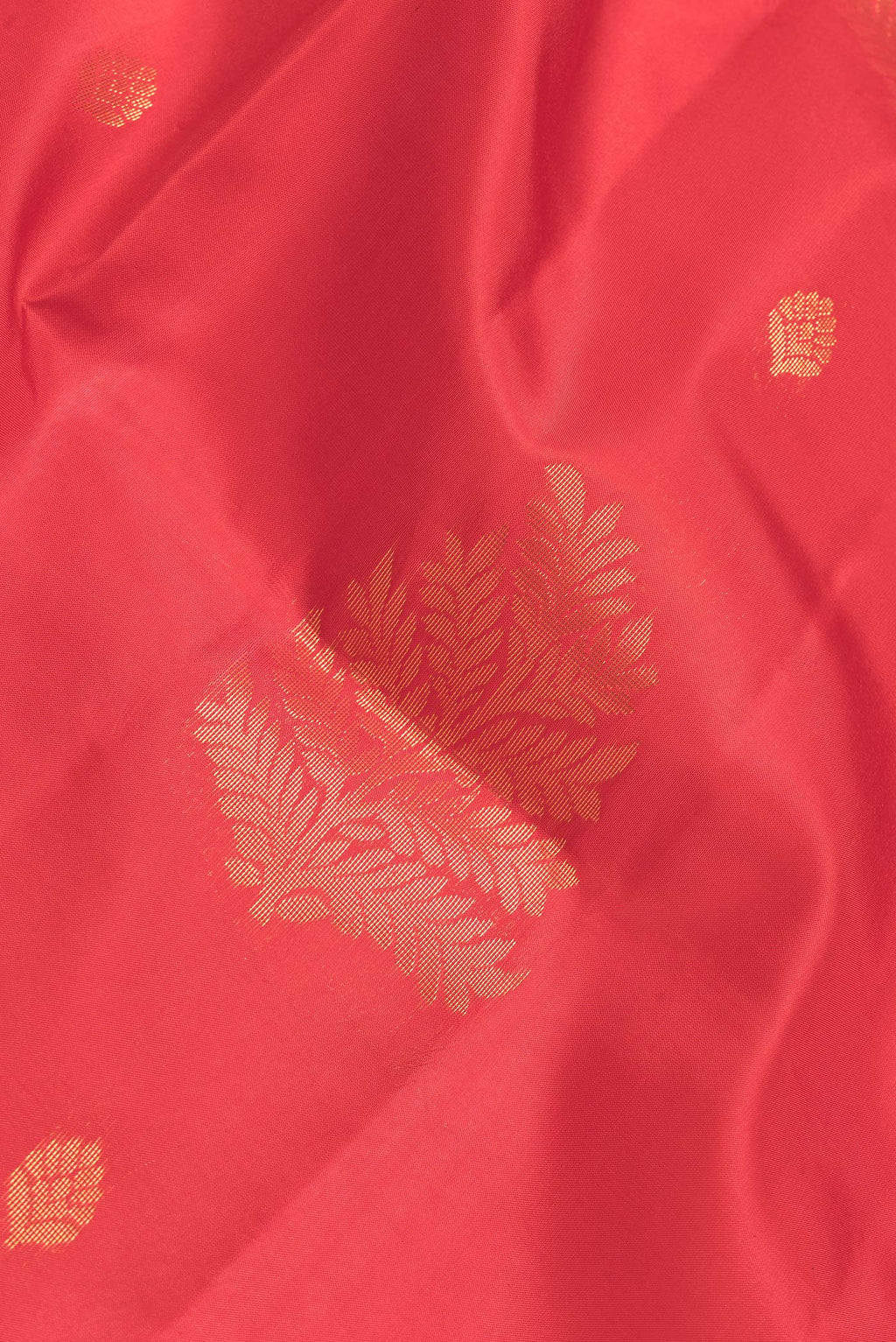 Close up of Red Dual Tone Soft Silk Saree with Zari Butta on the body and Fancy Border.  displaying folds