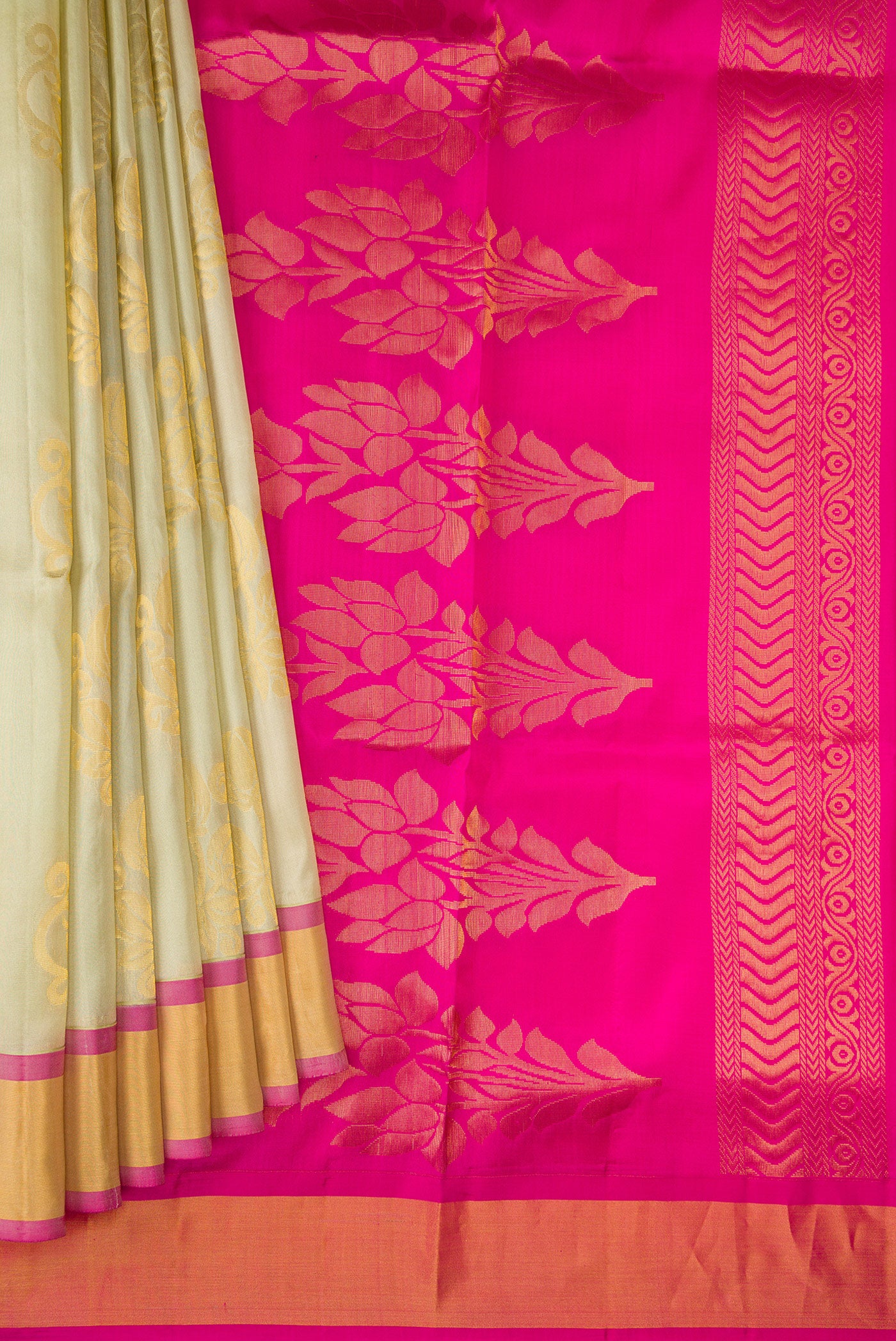 Pleats and pallu of Beige Soft Silk Saree with Zari Butta on the body and Zari Border. 