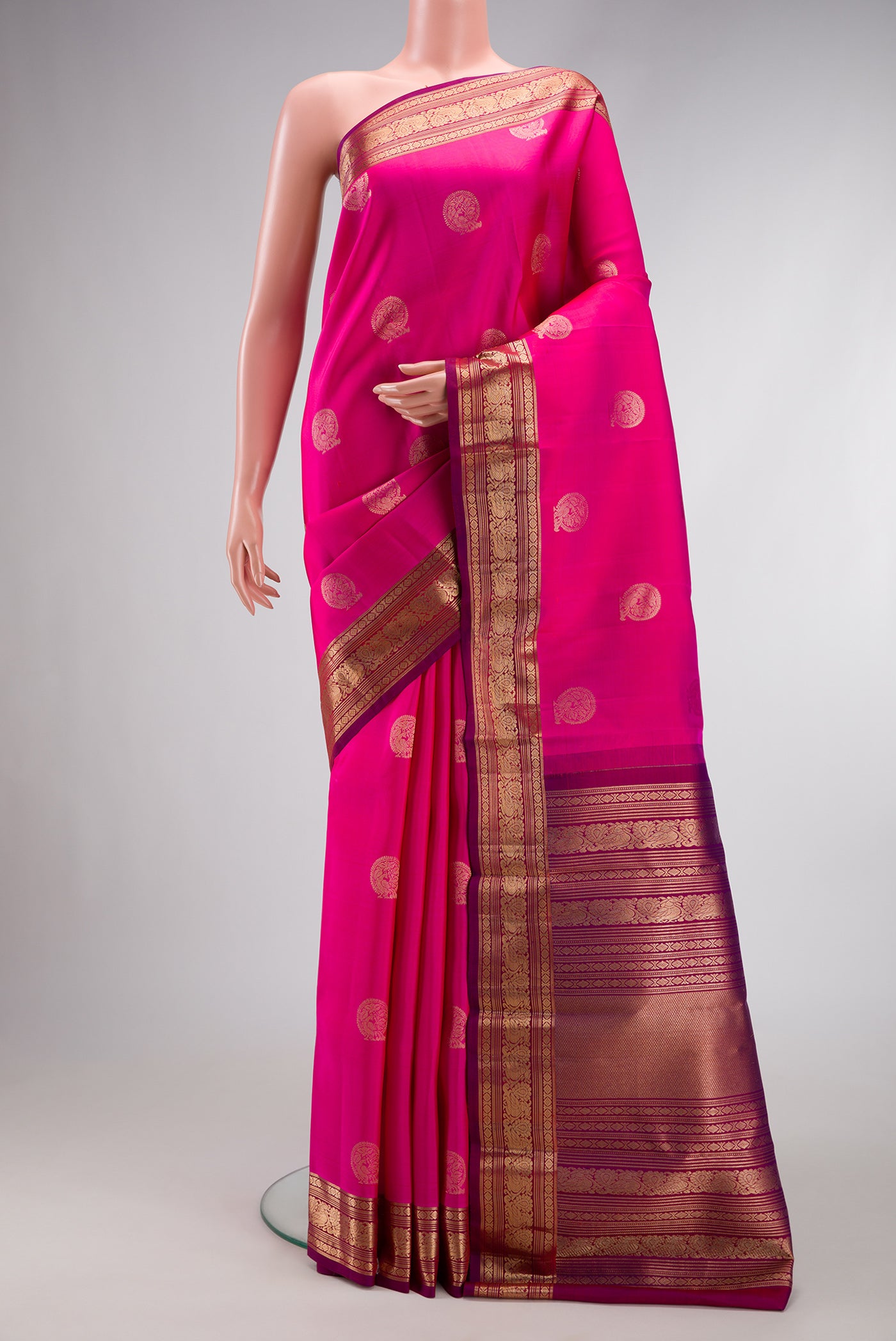 Pink Dual Tone Kanjivaram Silk Saree with Zari Butta on the body and Zari Border.  displayed on a mannequin