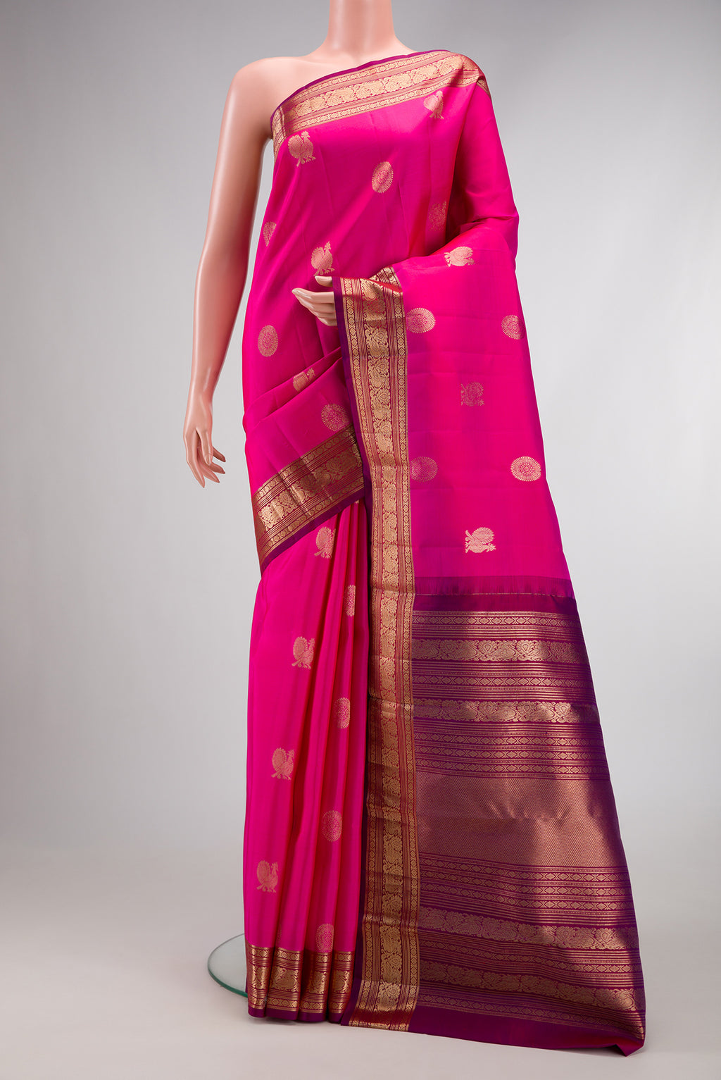 Pink Dual Tone Kanjivaram Silk Saree with Zari Butta on the body and Zari Border.  displayed on a mannequin