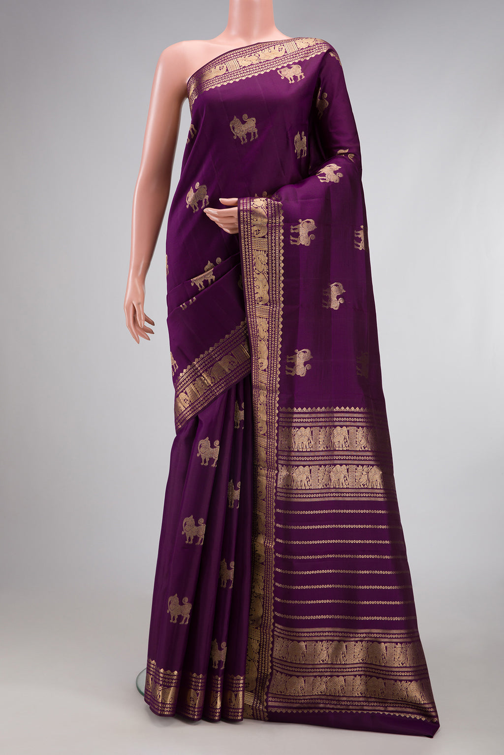 Purple Kanjivaram Silk Saree with Zari Butta on the body and Zari Border.  displayed on a mannequin