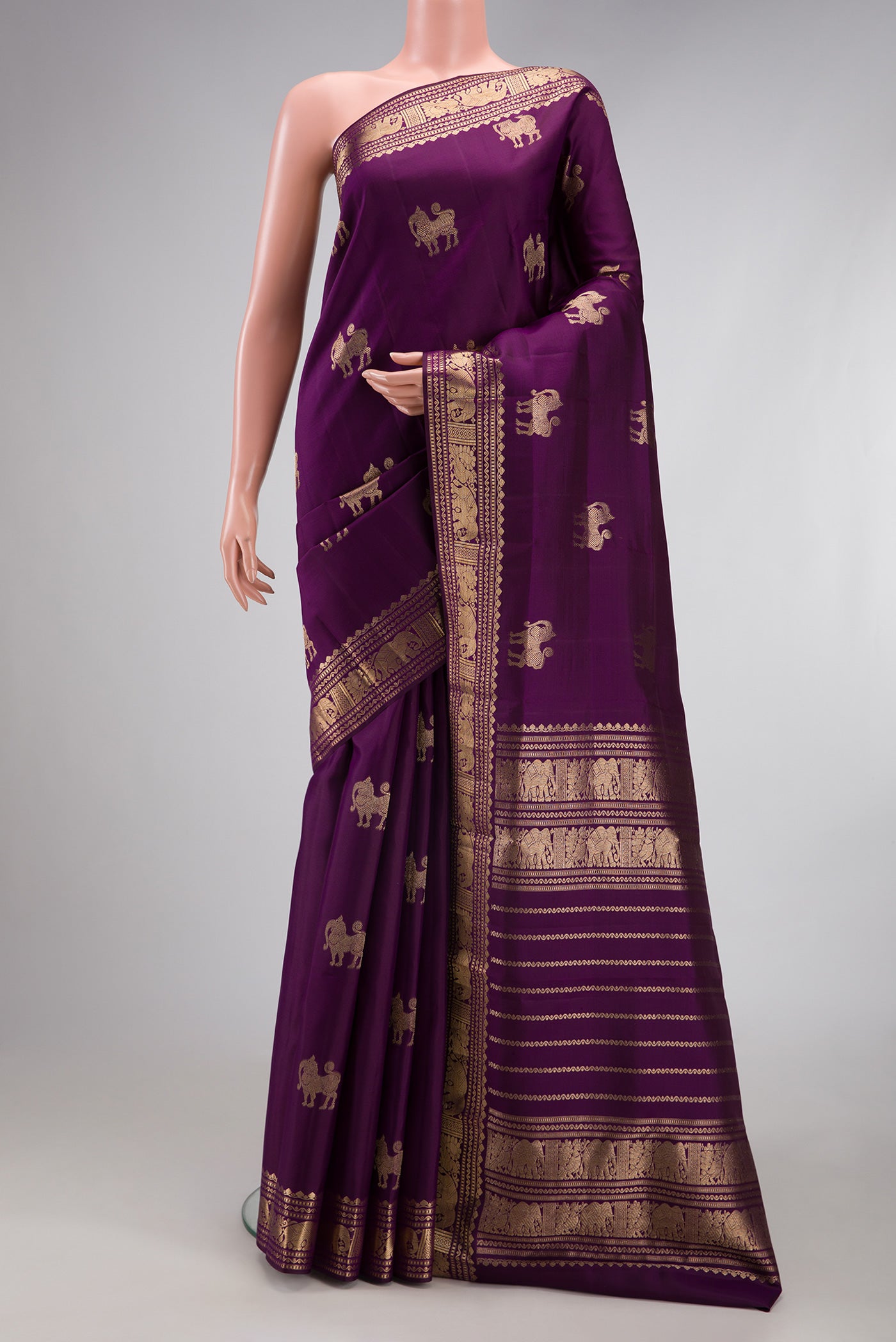 Purple Kanjivaram Silk Saree with Zari Butta on the body and Zari Border.  displayed on a mannequin