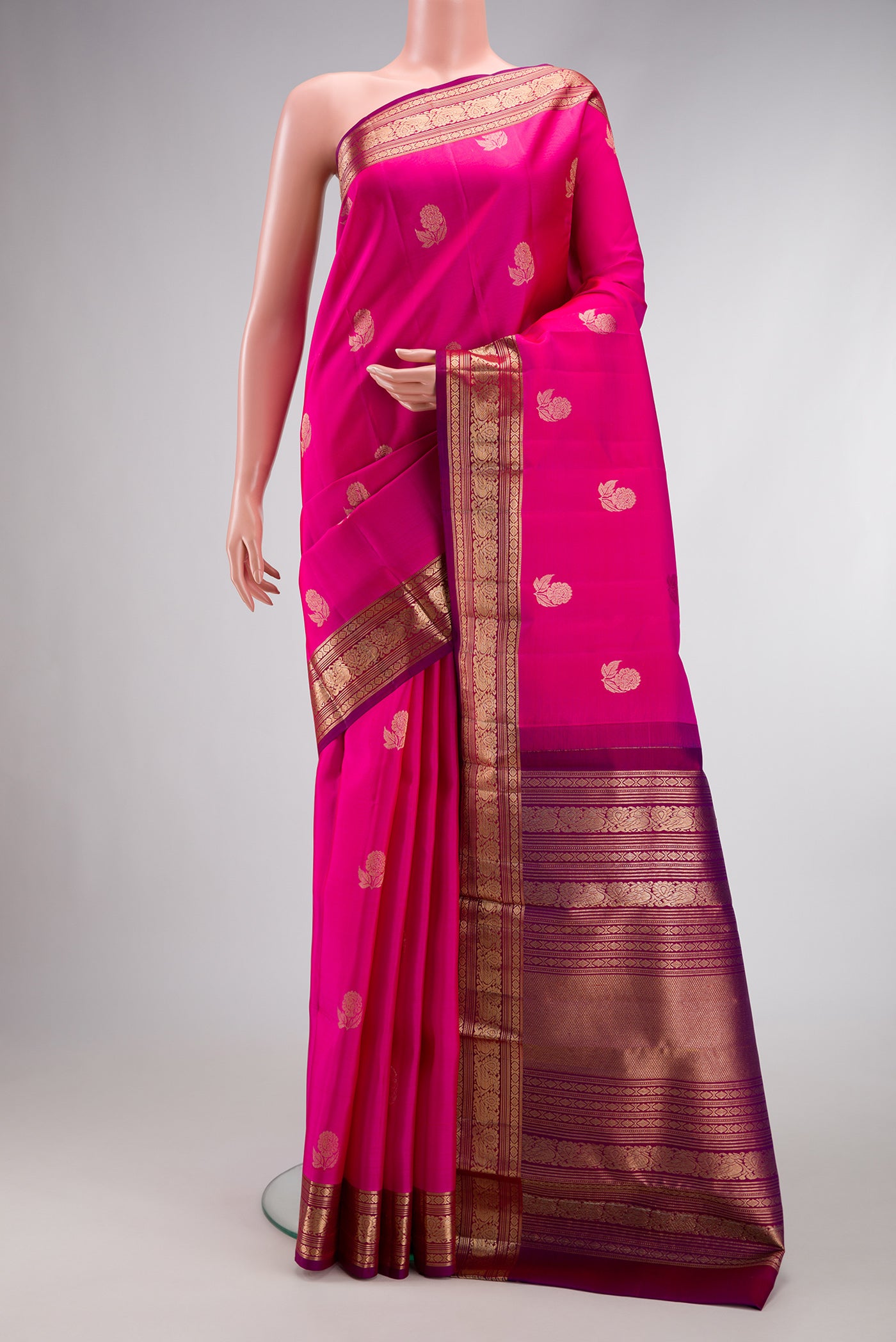 Magenta Dual Tone Kanjivaram Silk Saree with Zari Butta on the body and Zari Border.  displayed on a mannequin