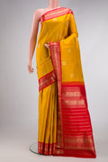 Yellow Dual Tone Kanchipuram Silk Saree with Zari Butta on the body and Zari Border.  displayed on a mannequin