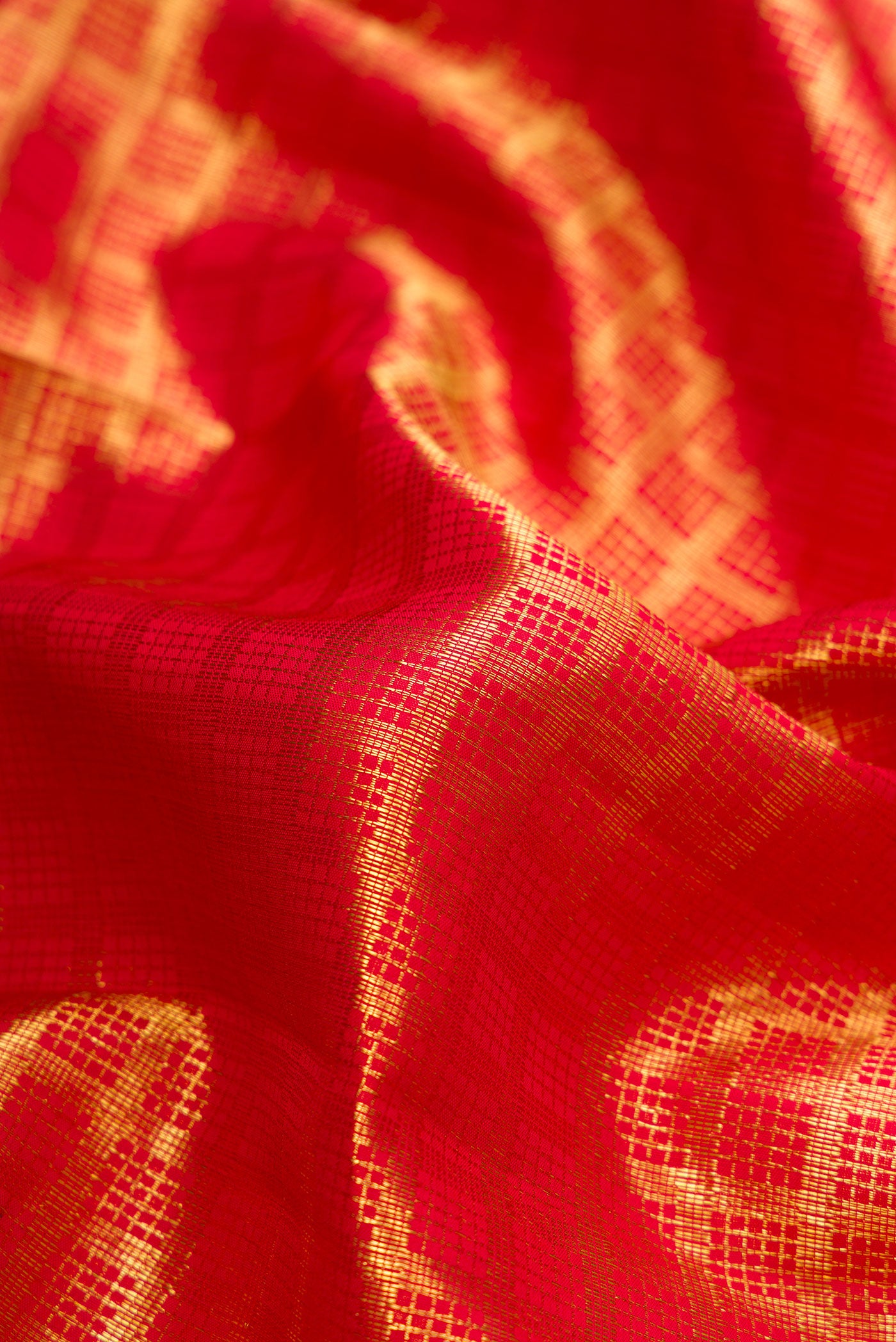 Close up of Red Dual Tone Kanchipuram Silk Saree with Zari Brocade on the body and Zari Border.  displaying folds