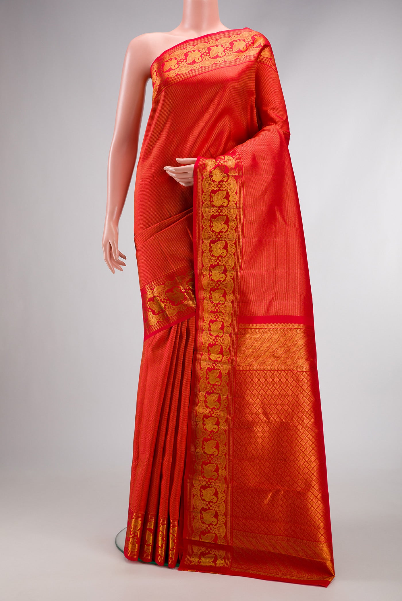 Red Dual Tone Kanchipuram Silk Saree with Zari Brocade on the body and Zari Border.  displayed on a mannequin