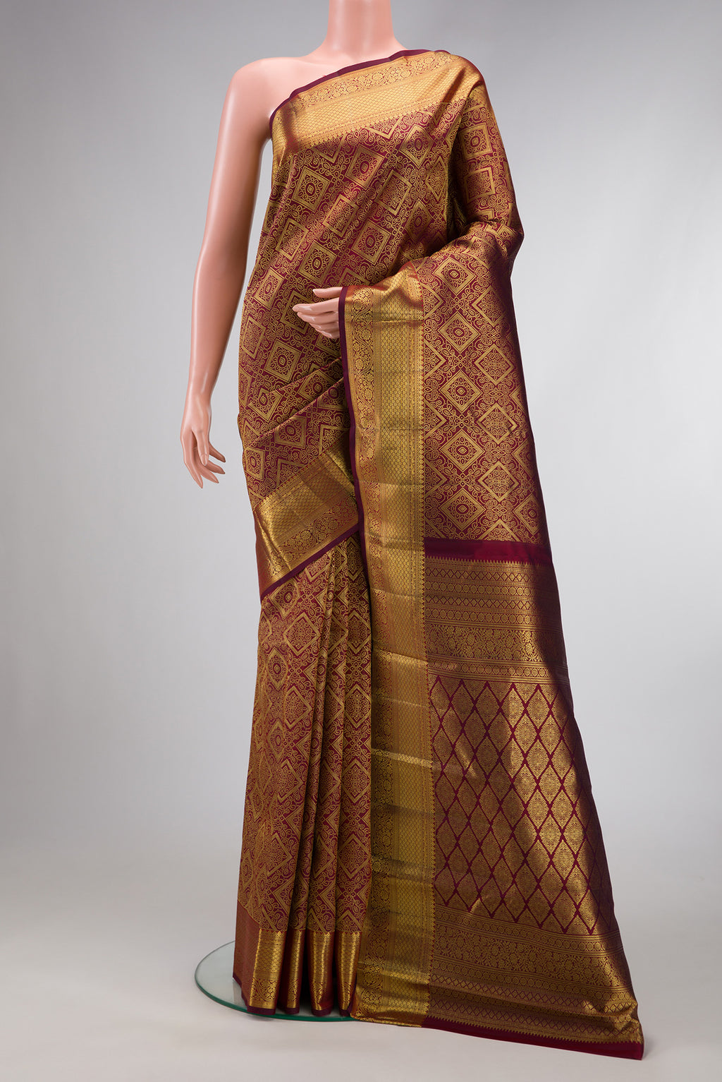 Maroon Dual Tone Kanchipuram Silk Saree with Zari Brocade on the body and Zari Border.  displayed on a mannequin